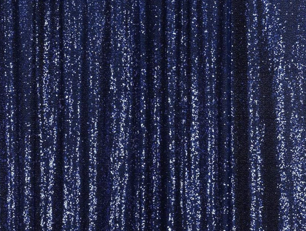 Close-up of shiny blue sequined fabric with vertical folds.