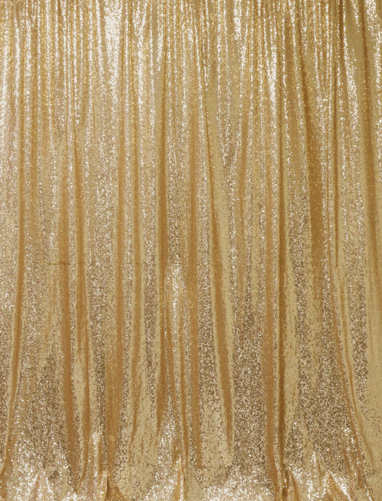 Gold curtain with vertical stripes and glittery accents.
