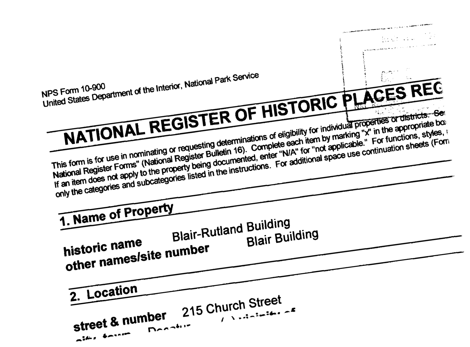Black and white photo of a partially visible form titled "National Register of Historic Places Registration" with handwritten entries for property name "Blair-Rutland Building," location "215 Church Street," and other details.