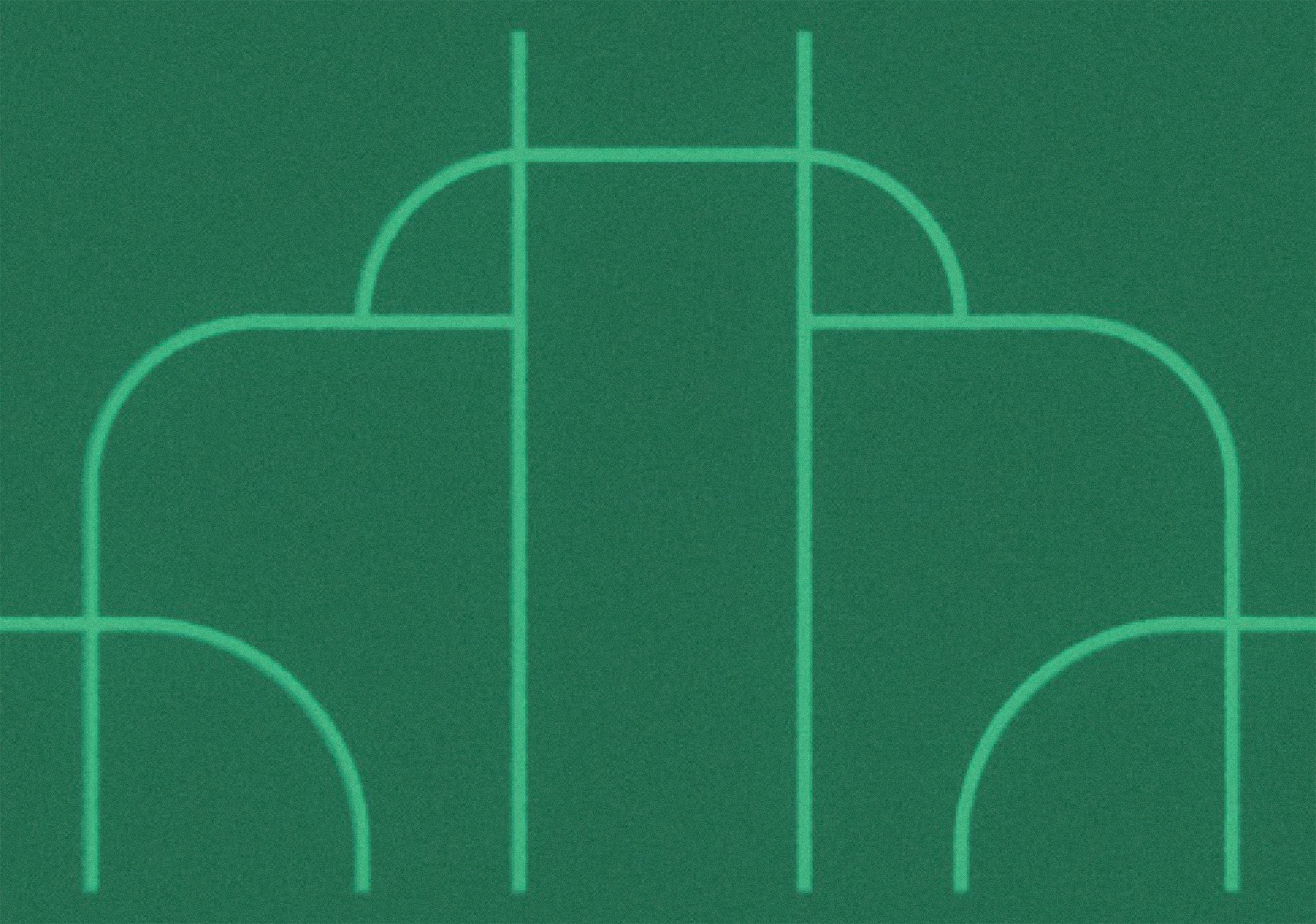 Close-up of a green cutting mat with white grid lines.