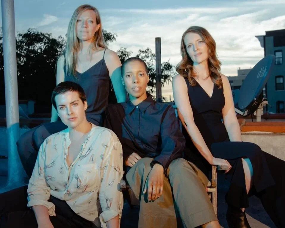 Members of the Overlook Quartet posing together outdoors in an ensemble portrait at dusk.