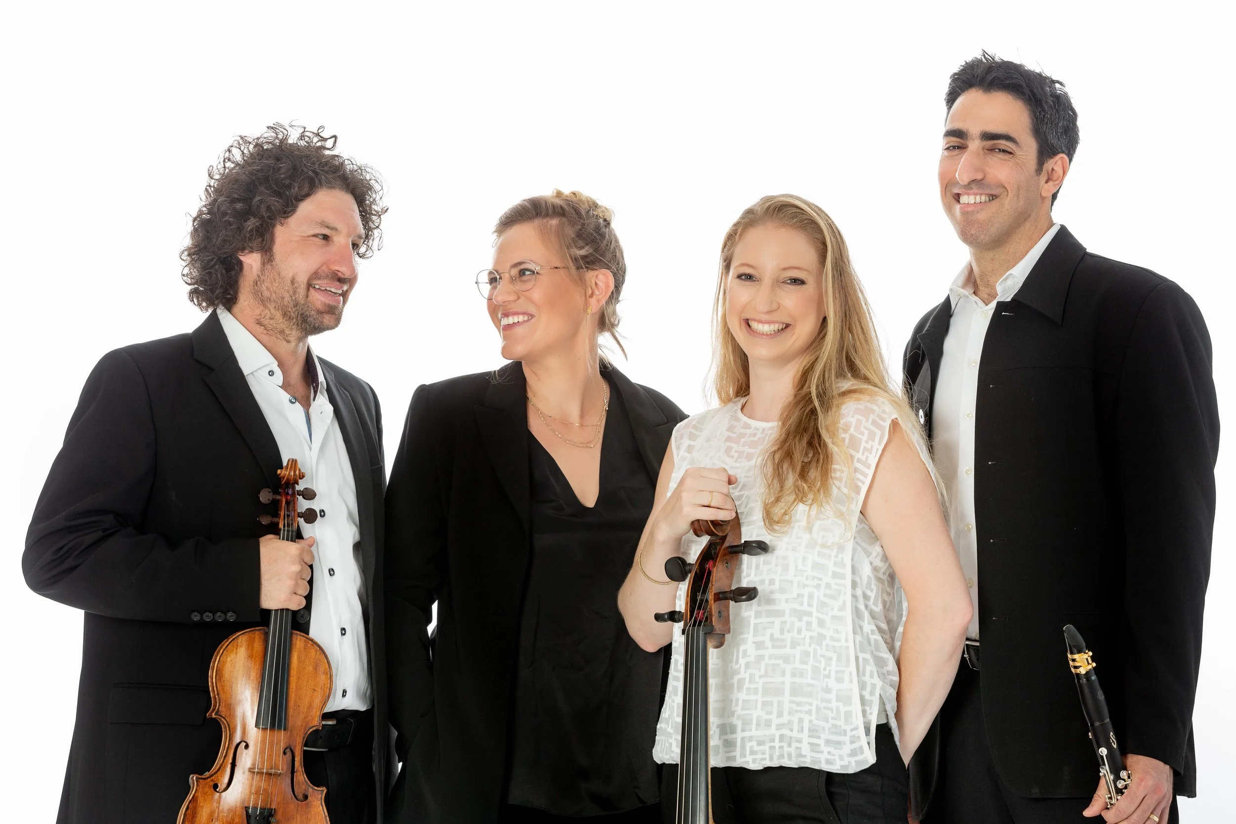 Israeli Chamber Project musicians smiling together in a studio portrait by photographer Yael Ilan.