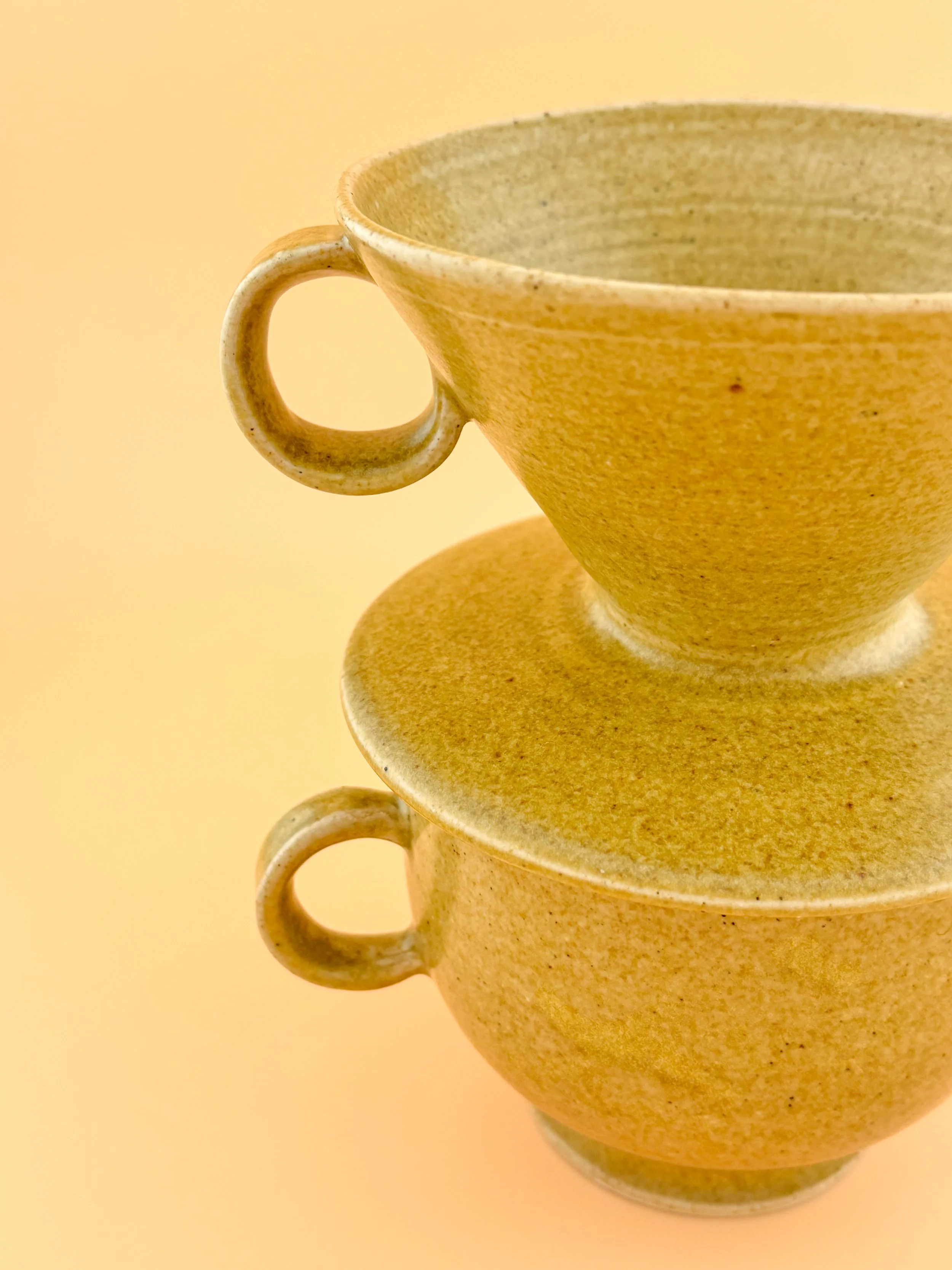Close-up of Golden Hour ceramic pour-over coffee dripper stacked on matching mug, showing glaze texture and handcrafted details.