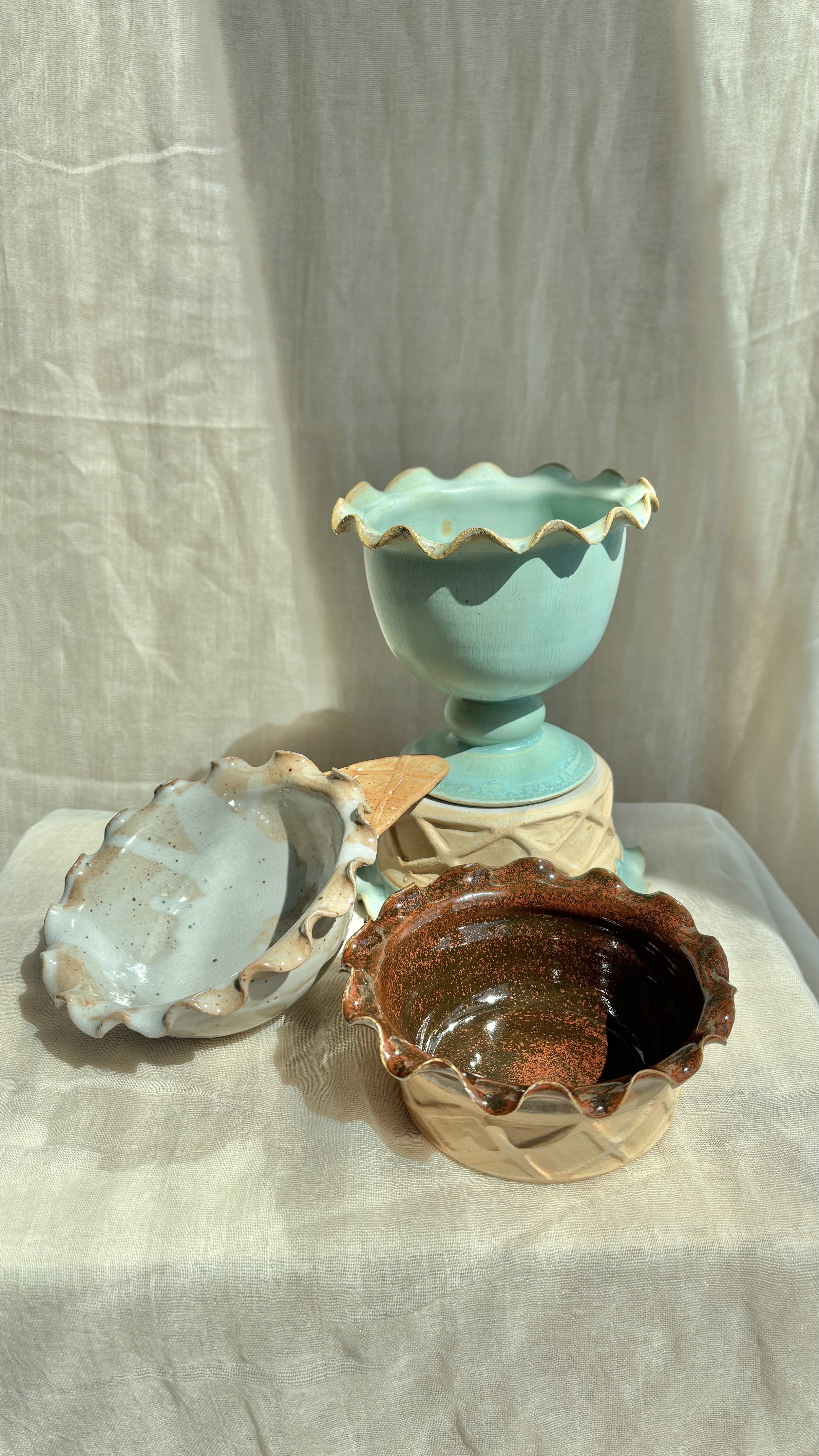 Handmade ceramic ice cream bowls in mint, salted caramel, and chocolate brownie styled on white linen.jpg