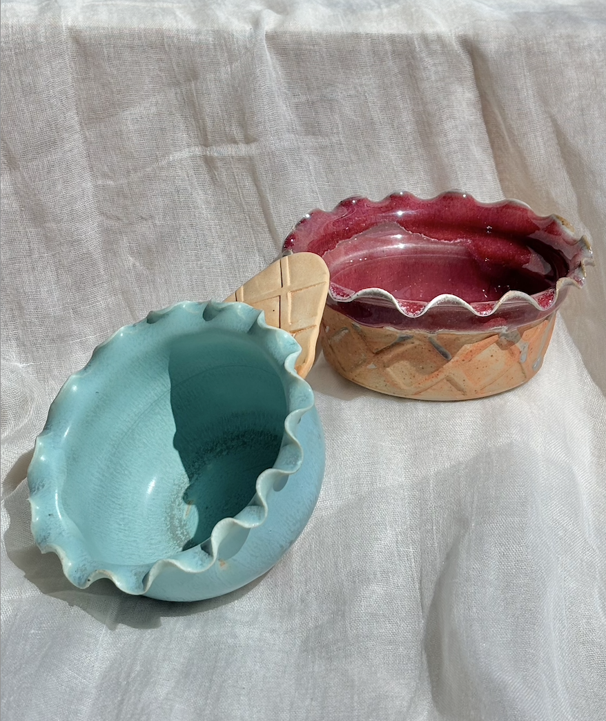 Handmade ceramic mint waffle cone and strawberry waffle cup ice cream bowls styled on white fabric.png