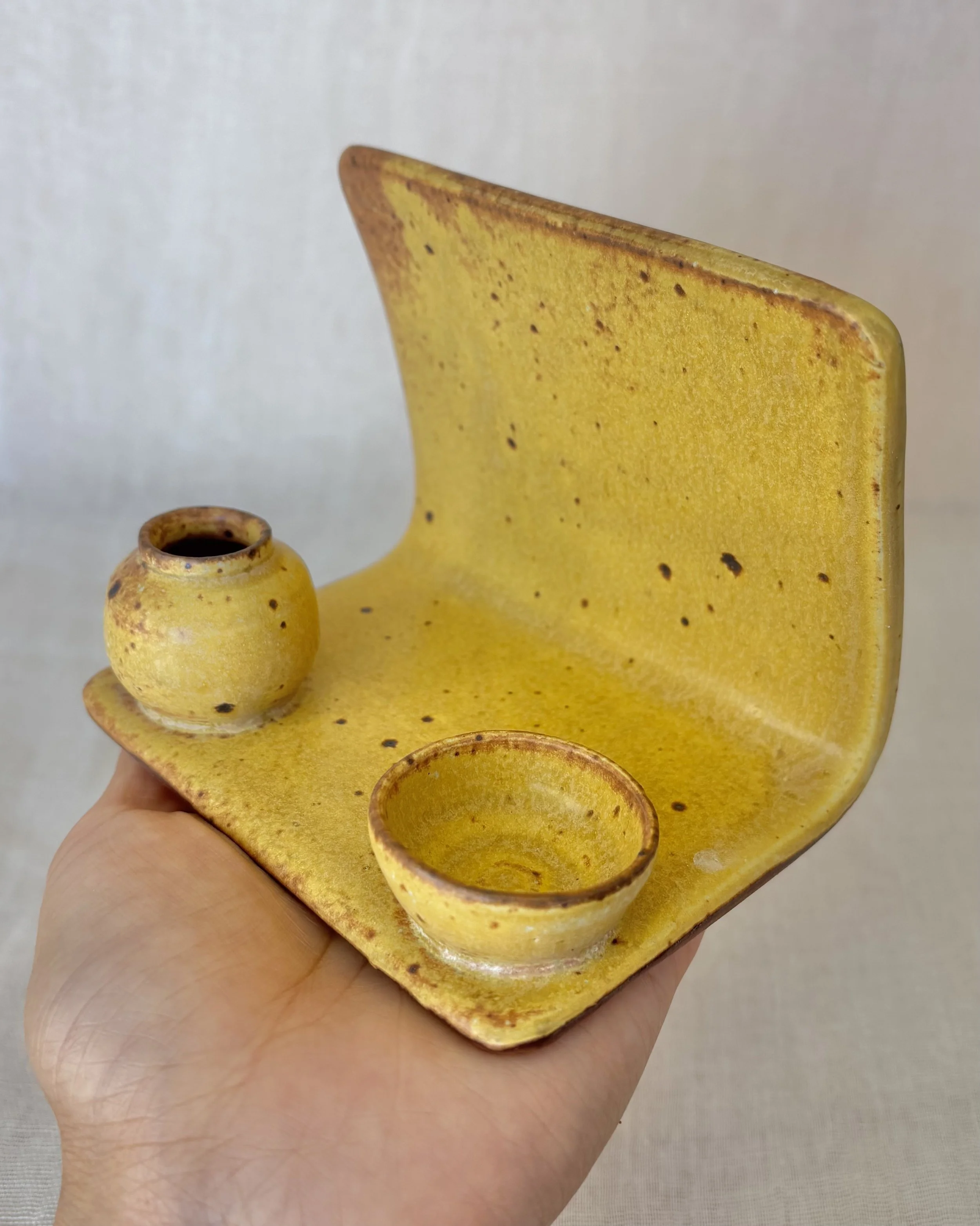 handmade-yellow-ceramic-phone-stand-in-hand.jpeg
