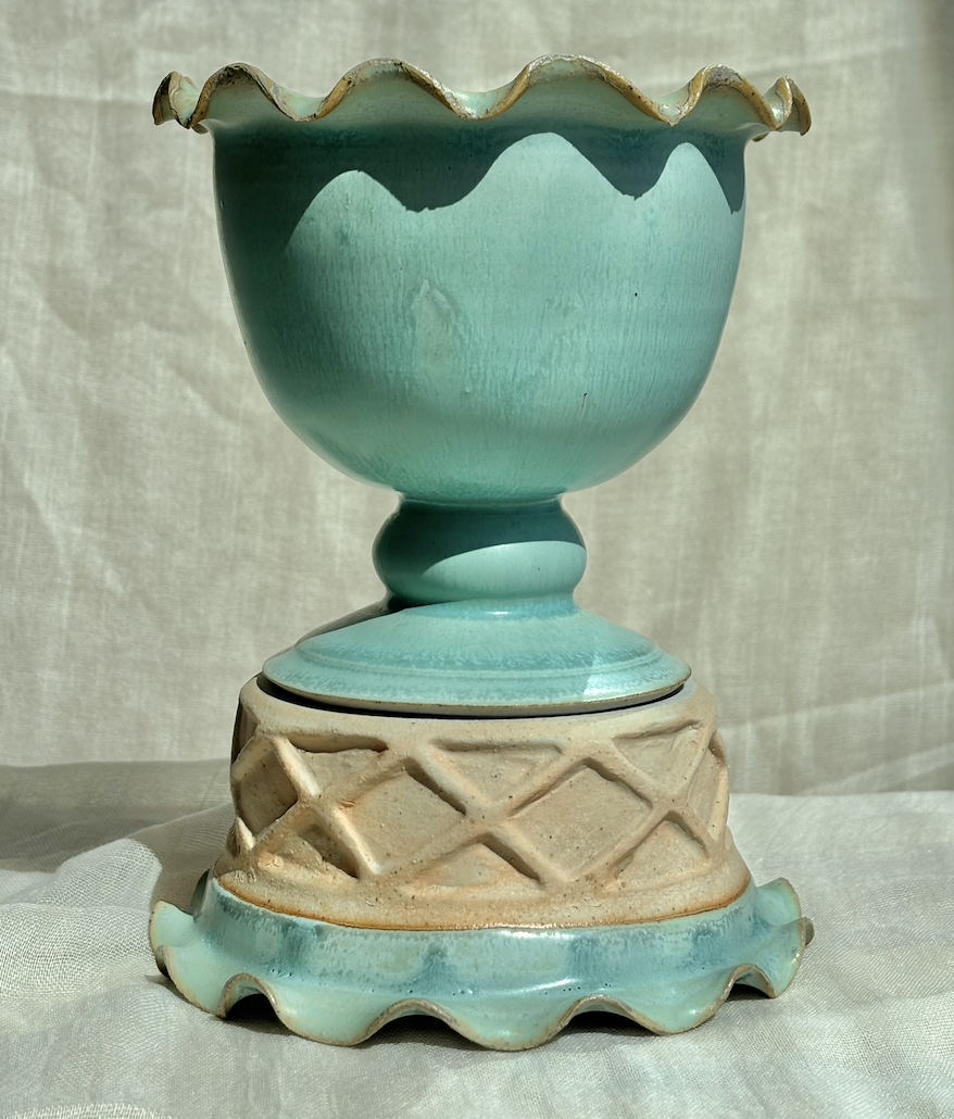 Handmade ceramic mint ice cream sundae pedestal bowl with ruffled rim on white linen.png