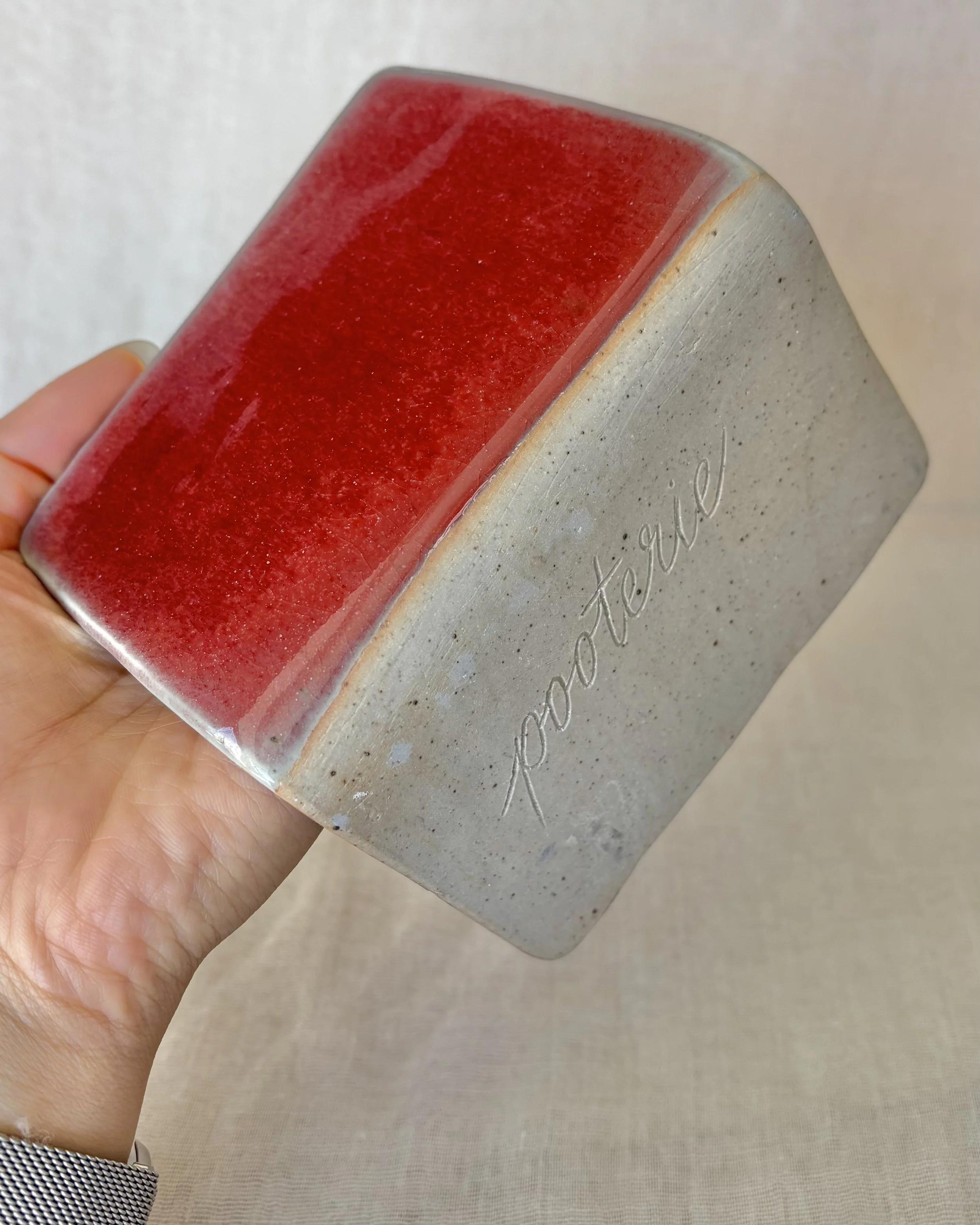 stoneware-card-holder-back-view-red-glaze-unglazed-base.jpeg