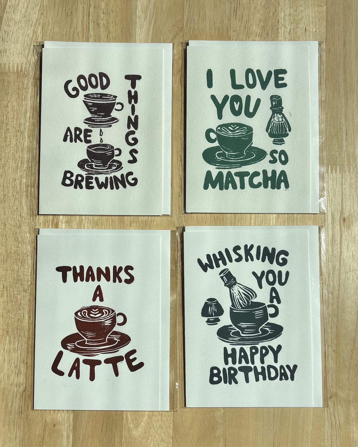 All four Pooterie Studio linocut greeting card designs displayed together.png (Copy)