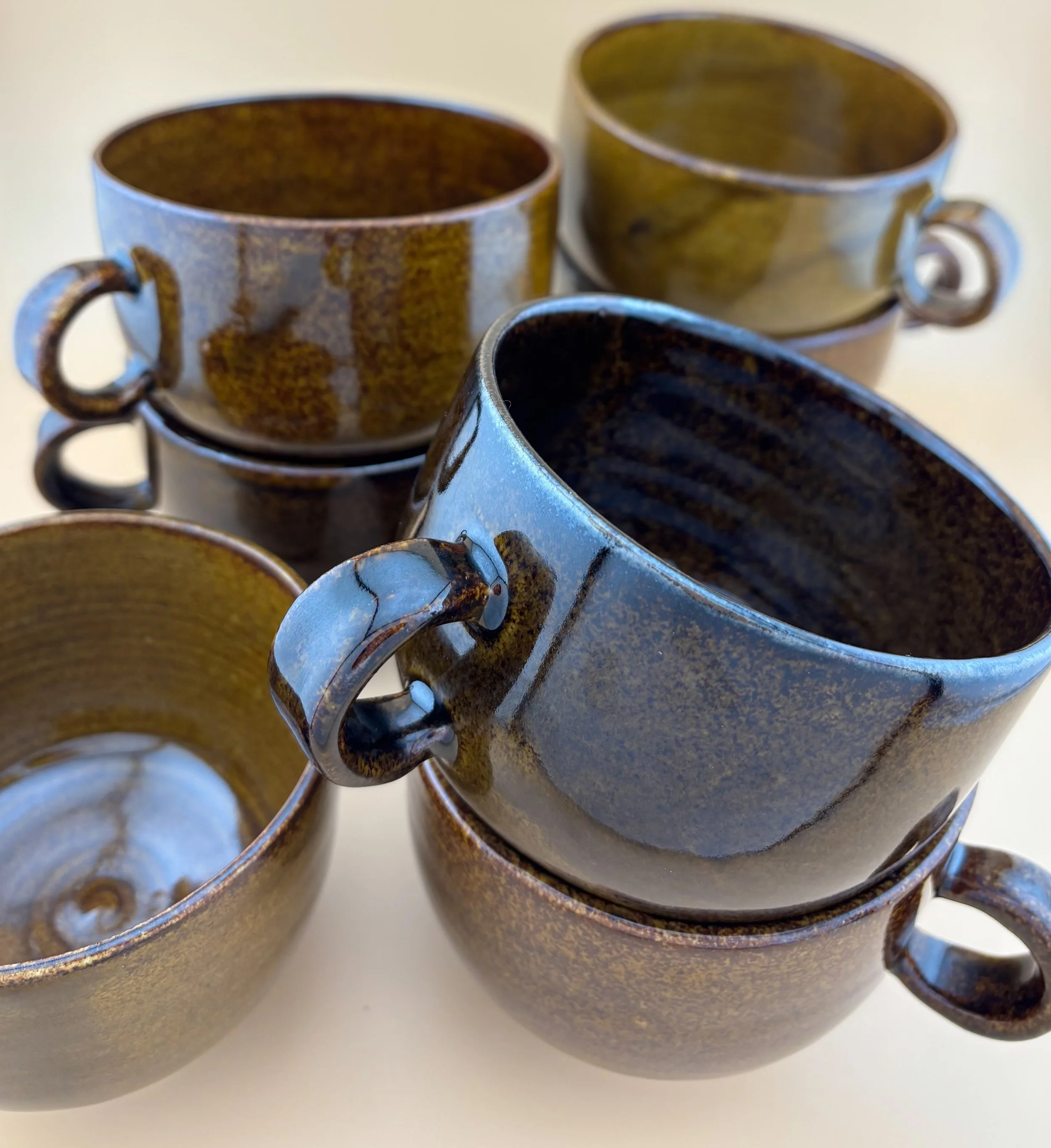 Handmade ceramic matcha mugs in Dark Roast glaze, featuring wheel-thrown texture, warm brown hues, and modern handled design.