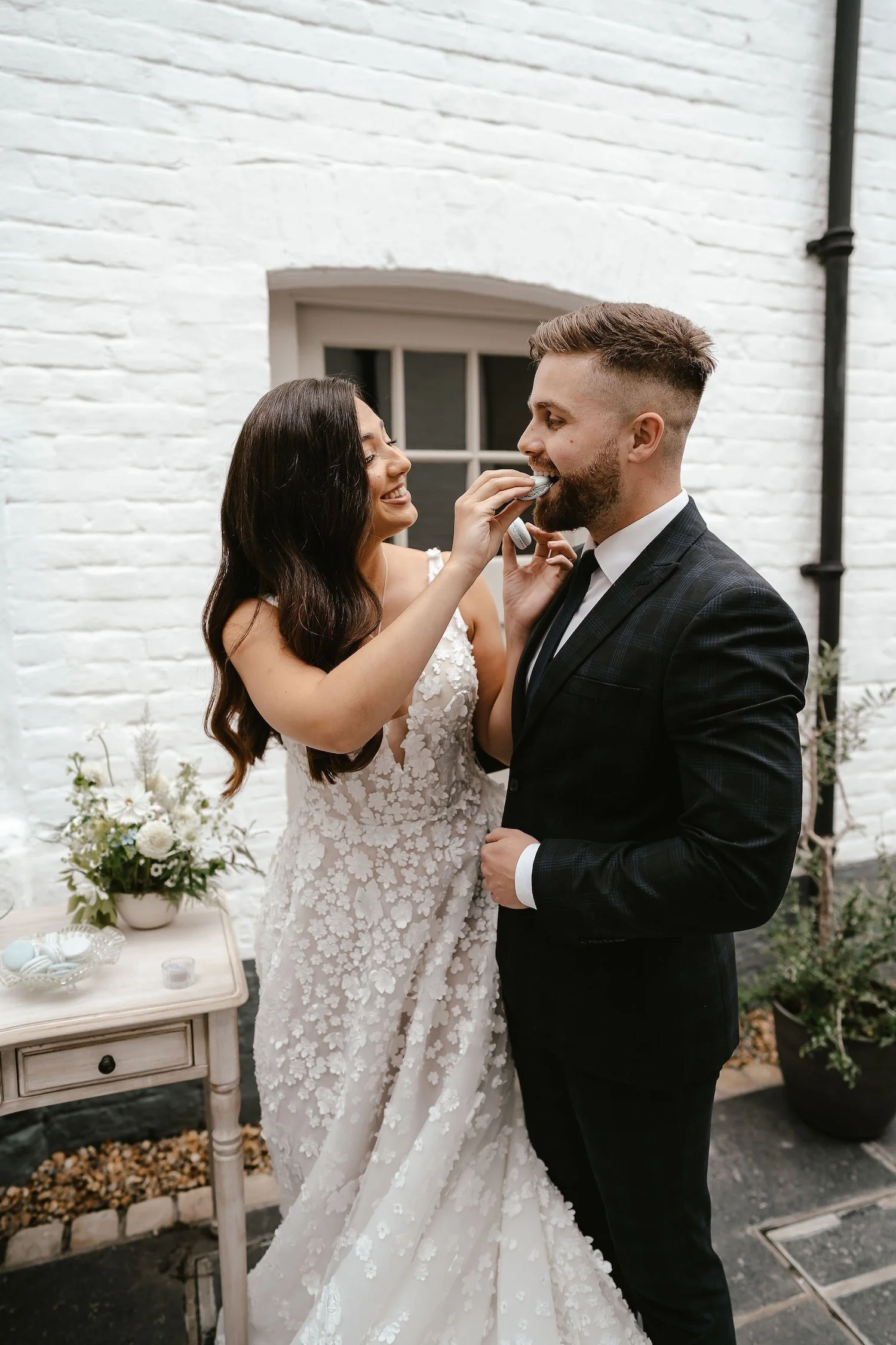 A bride playfully feeding a groom