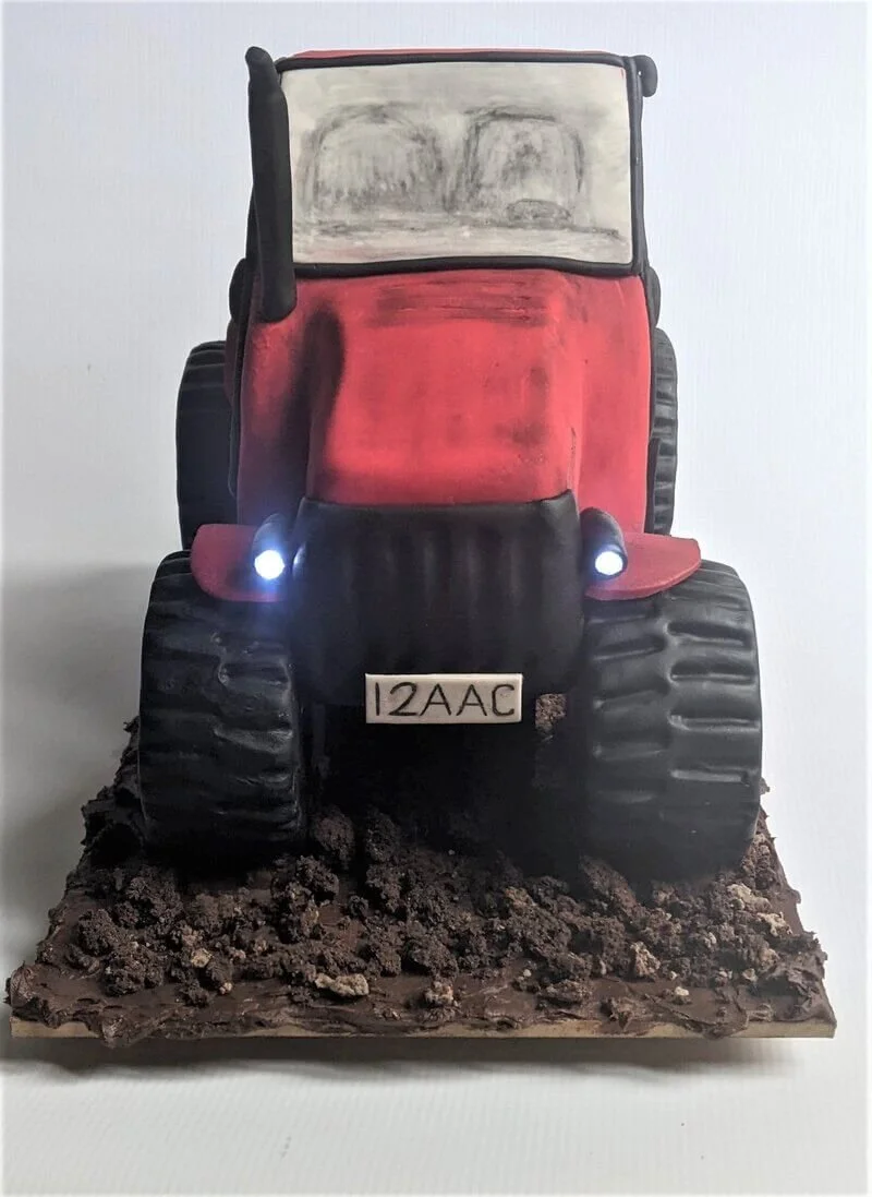 Carved birthday cake shaped like a tractor