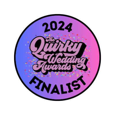 A circular badge with a purple and pink gradient background, featuring the text '2024 The Quirky Wedding Awards Finalist' in the center, surrounded by colorful confetti.