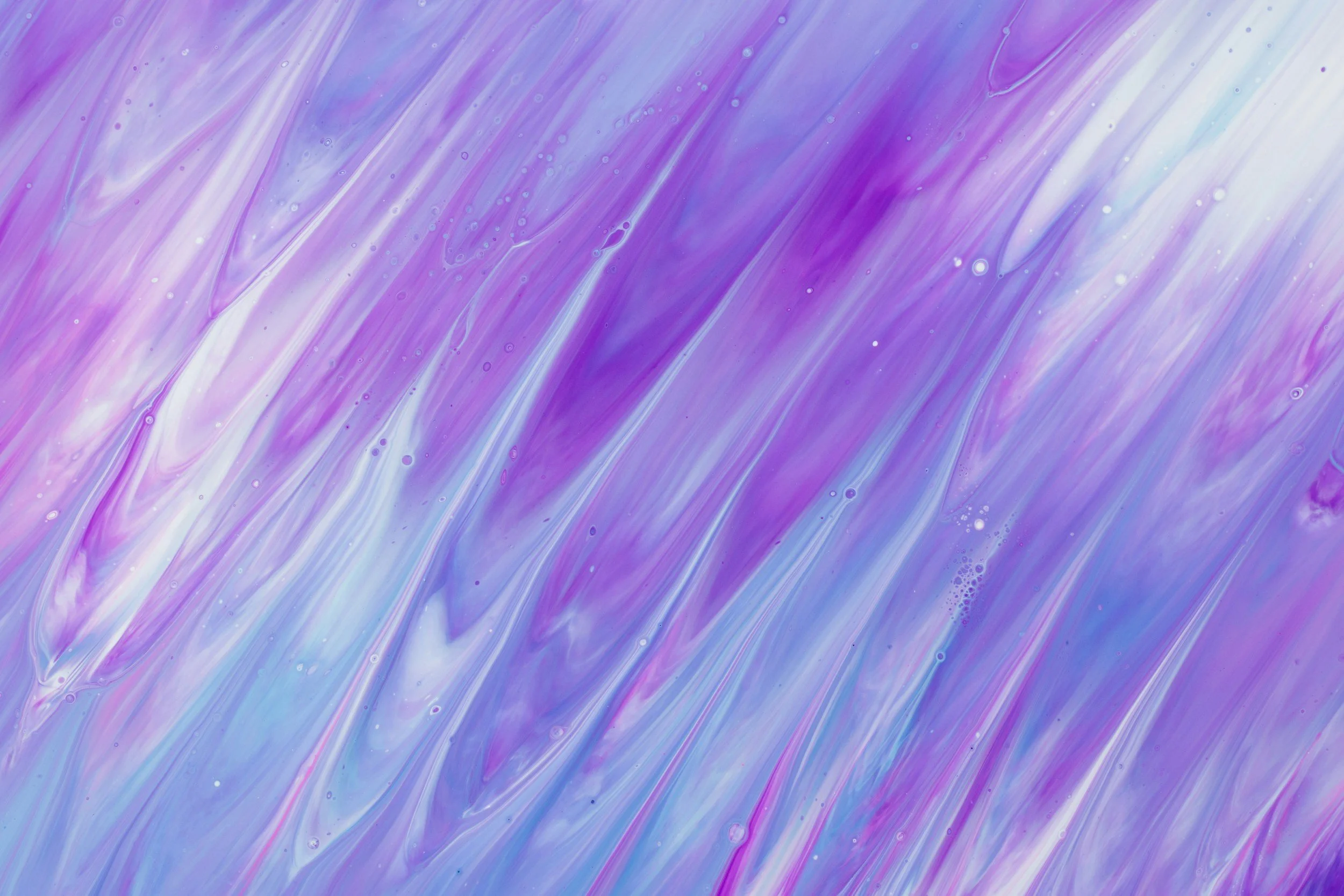 Abstract background with swirls and streaks of purple, white, and light blue colors, resembling flowing watercolor or marbled paint.