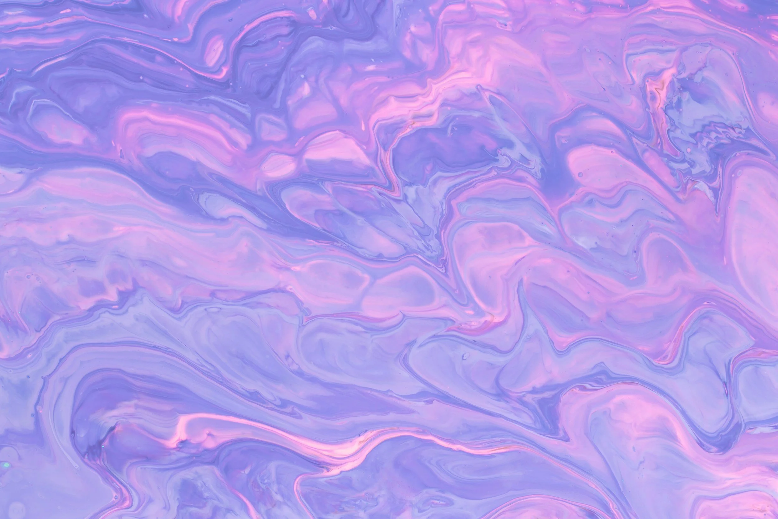 Swirling pastel-colored abstract background in shades of purple, pink, and blue.