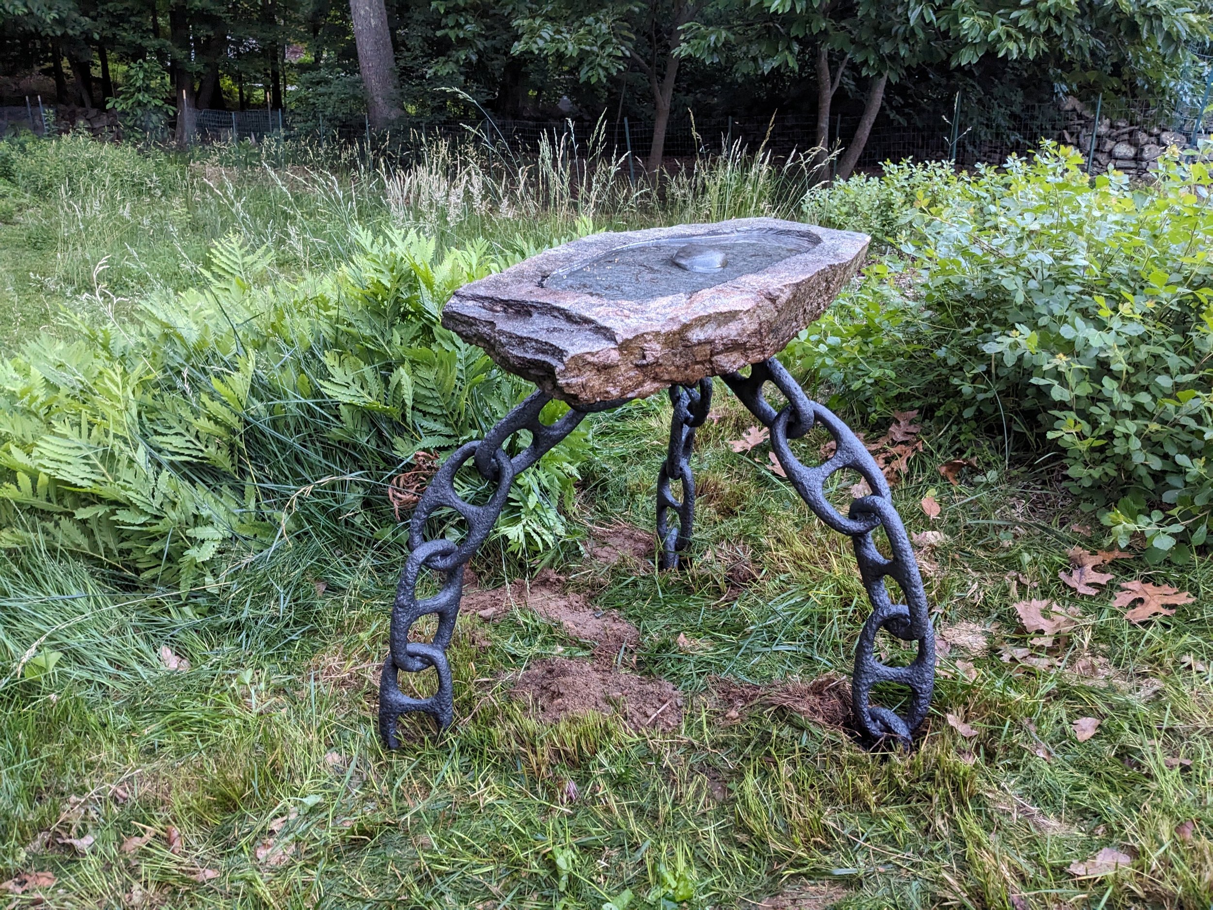 Hand carved granite bird bath with welded chain legs