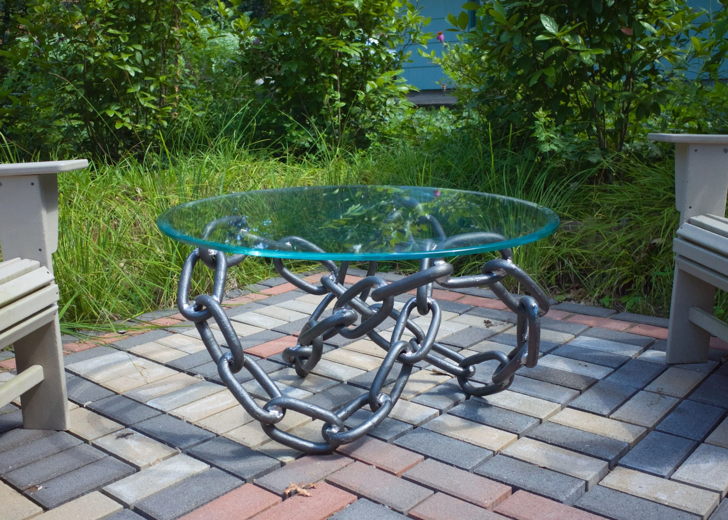 Trefoil knot welded table base with 36" diameter glass top