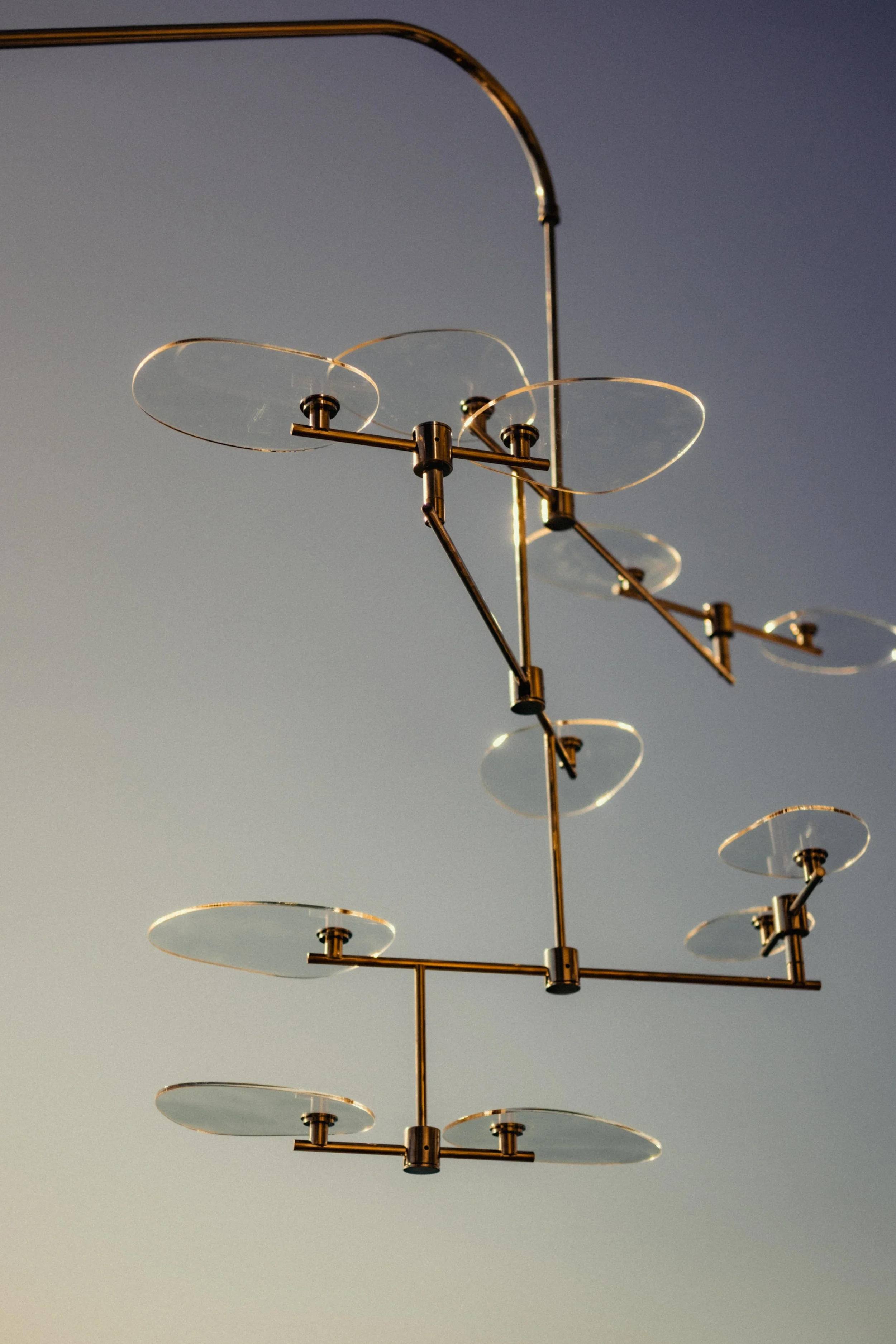 A modern metallic weather satellite antenna with multiple circular, flat panels against a clear sky.