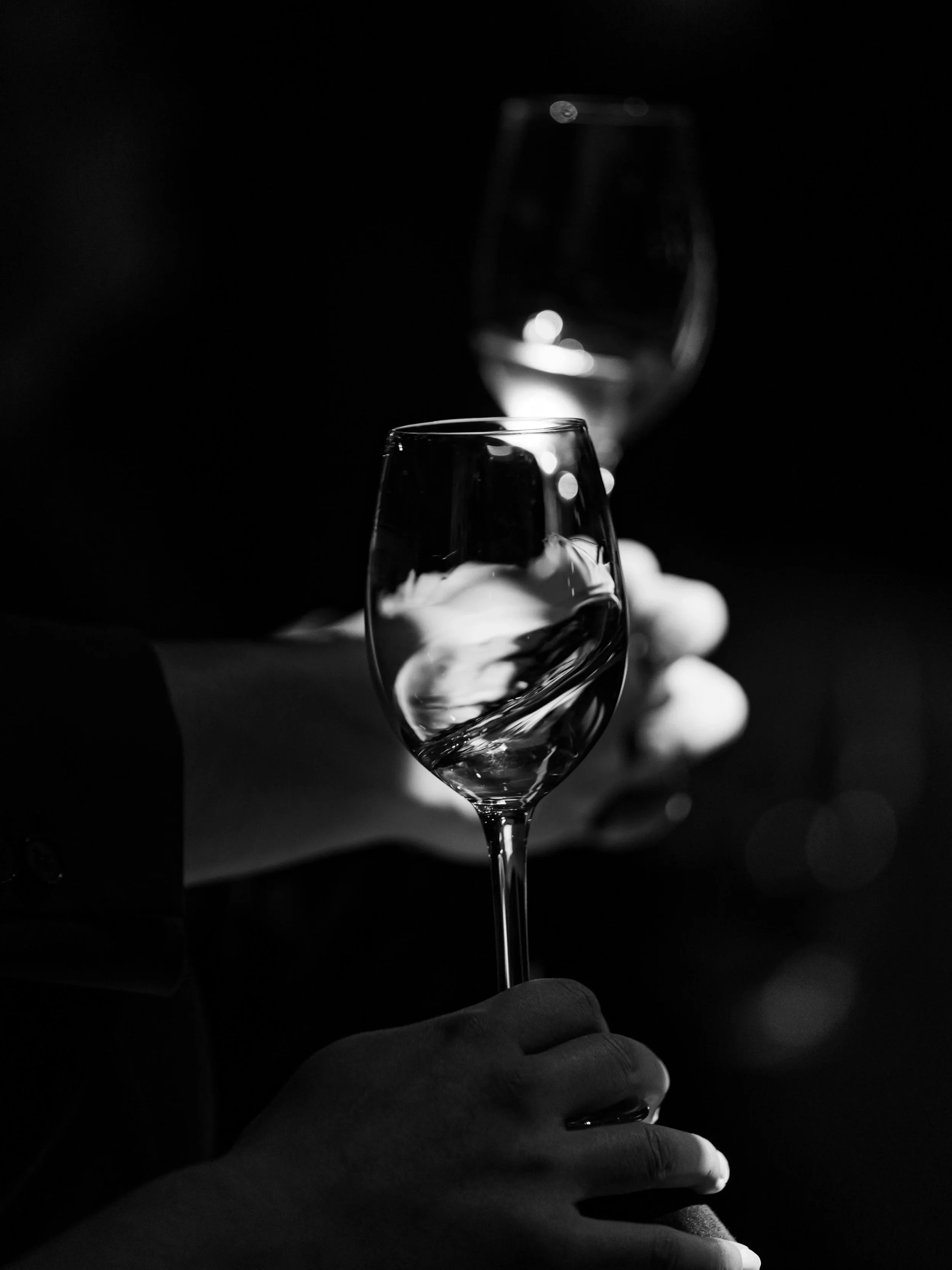 black and white image of waiter holding a glass