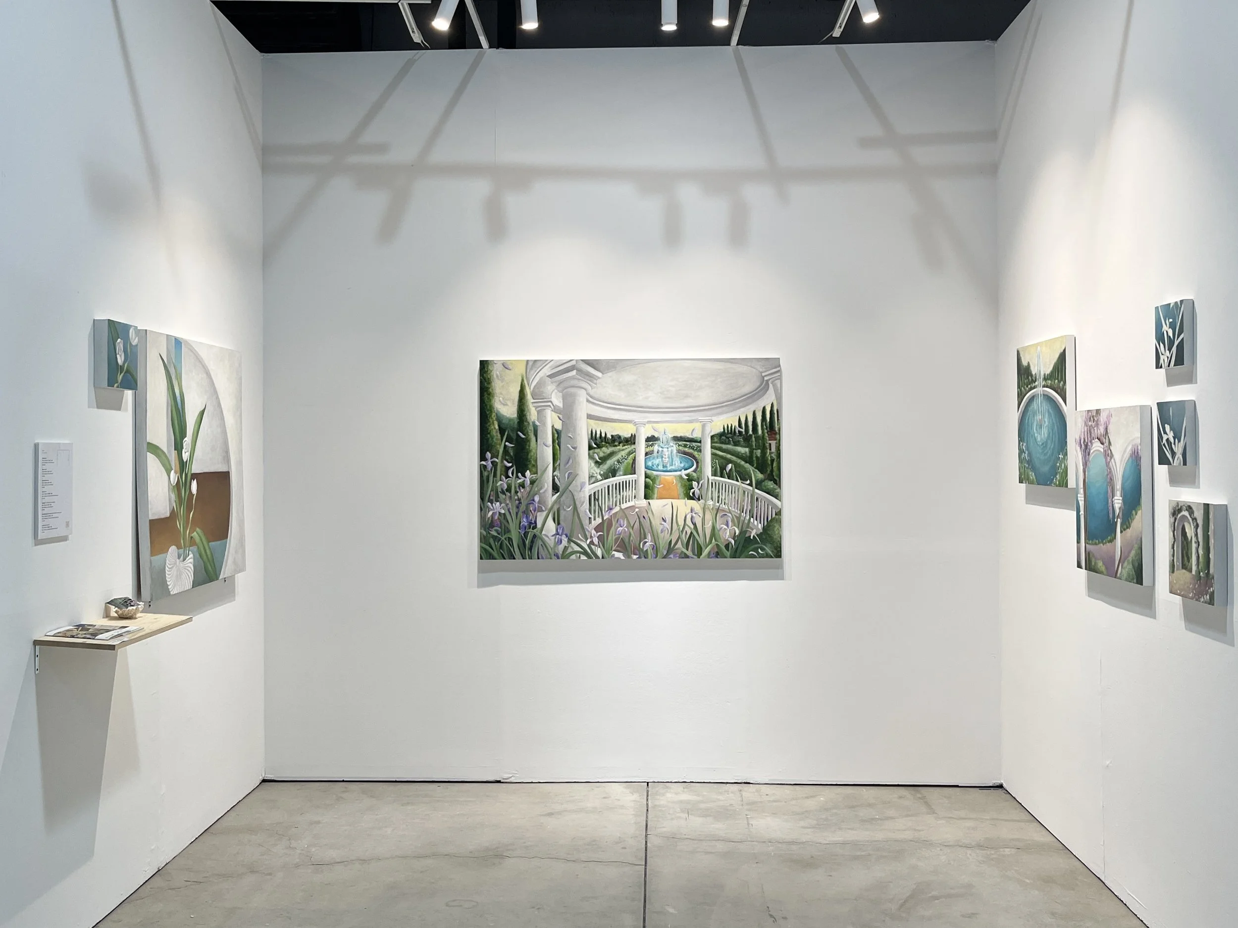  Tsai Yu-Chen's works
Art gallery with white walls displaying several landscape paintings, including a central painting of a garden with a fountain, columns, and greenery. The gallery has a concrete floor and ceiling-mounted track lighting.