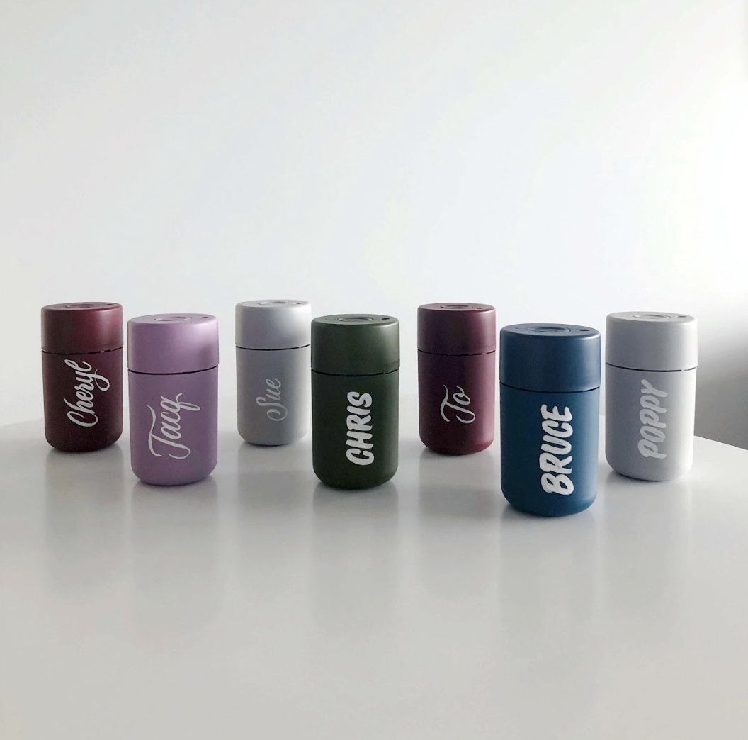 A range of reusable coffee cups, tastefully personalised with beautifully hand lettered names, done in flowy script calligraphy and block letters. Hand painted lettering work by Wanissa, an artist based in Melbourne Australia.