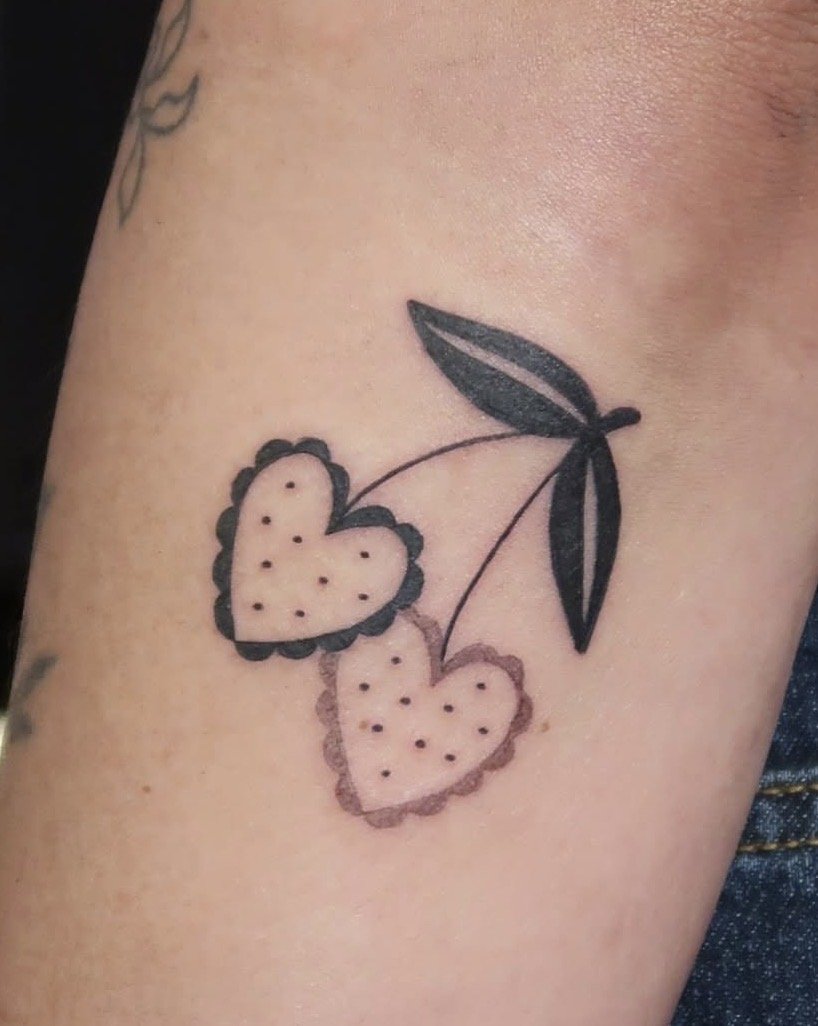 Tattoo of heart shapes cherries with polka dots. Cute and unique tattoo ideas by Wanissa, an Asian female tattooer in Melbourne, specialised in florals, tiles and ornamental tattoos.