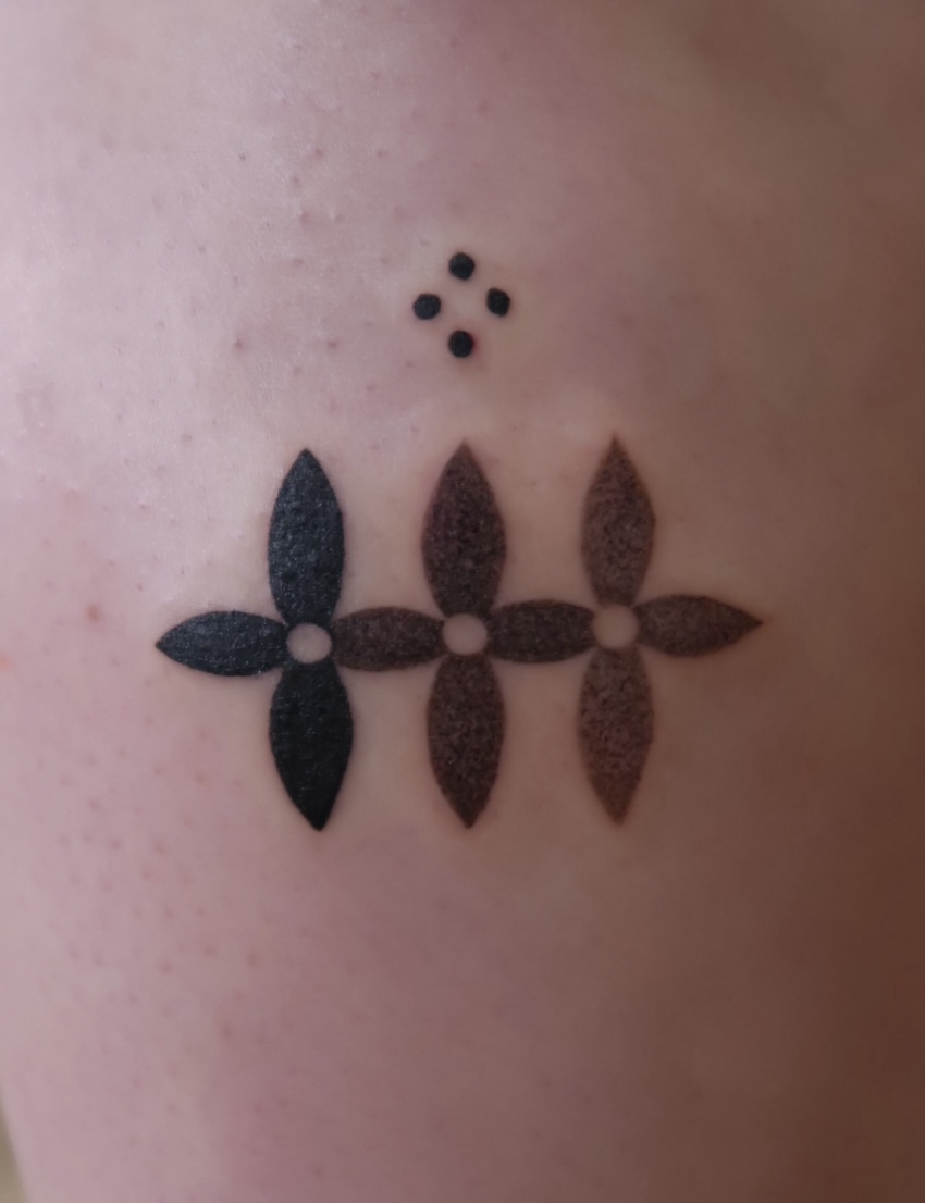 A tattoo of a floral motif, expressed in black to lighter shades of grey gradient. Work by Wanissa, a tattoo artist exploring cultural tiles, florals and ornaments.
