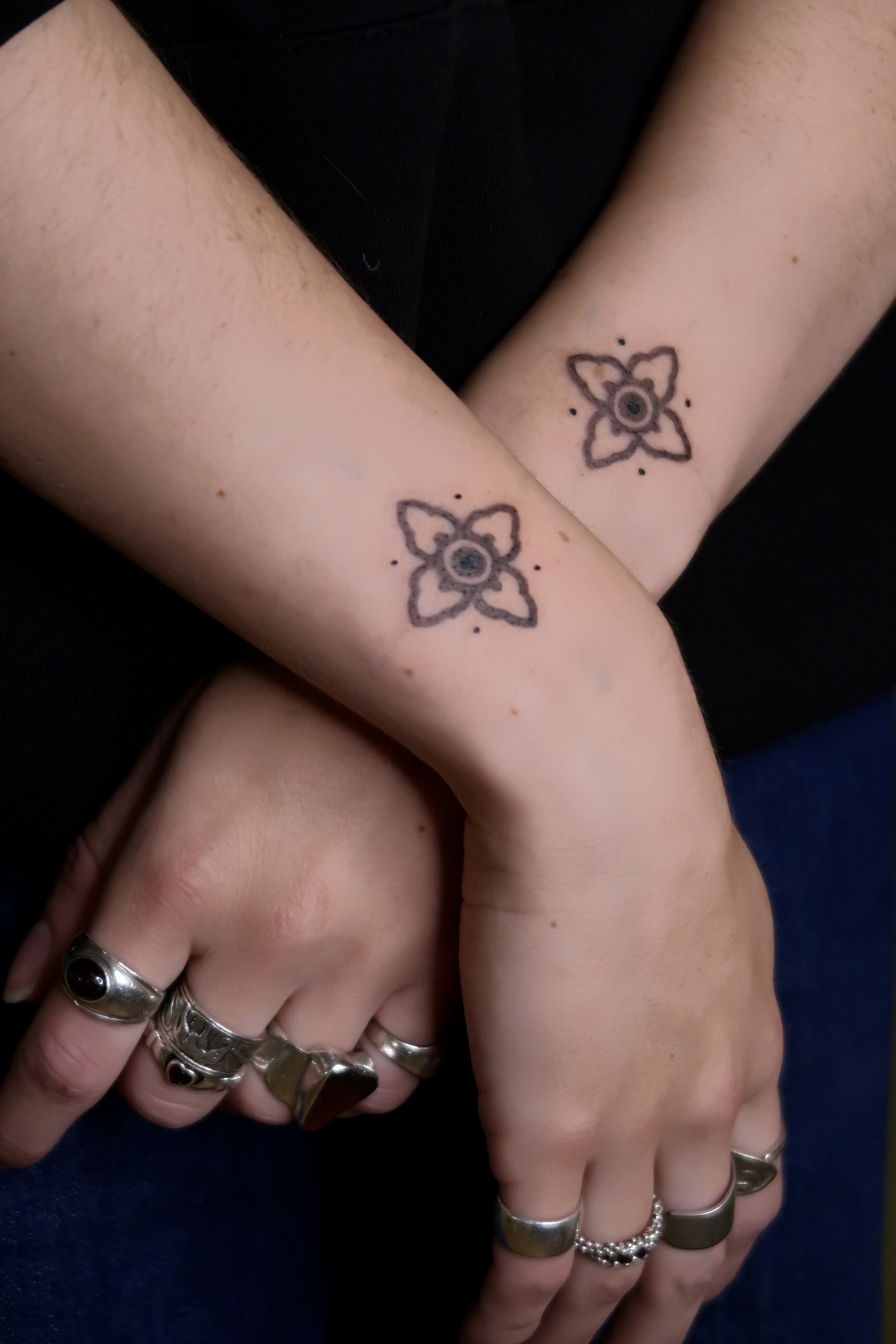 A tattoo of symmetrical floral tiles on the wrist, done with soft, stippled shading. Work by Wanissa, an Asian female tattoo artist based in Melbourne, Australia, specialised in beautiful ornaments and floral tattoos.
