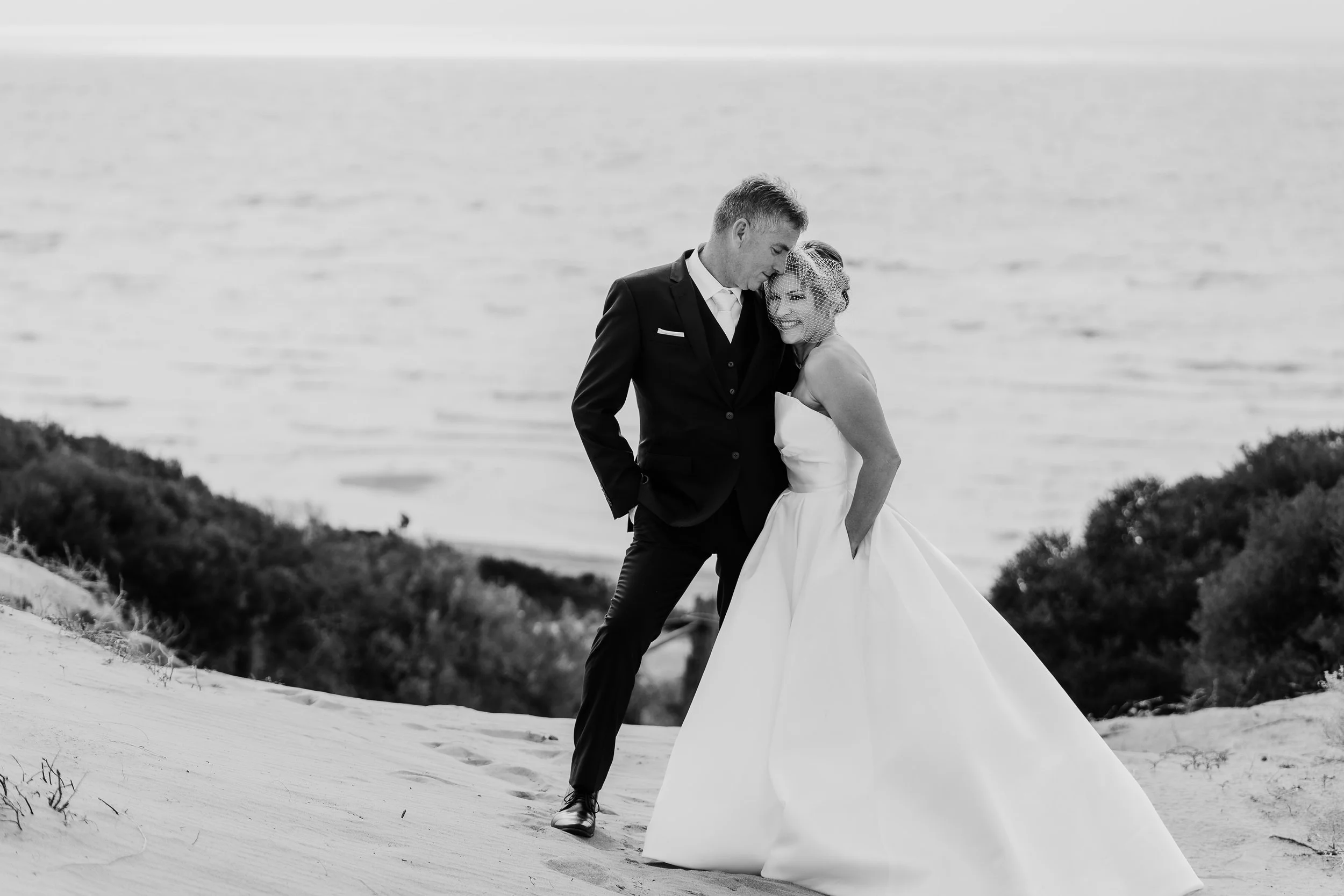 man and woman cuddle on ceduna sand dune during their wedding eyre peninsula