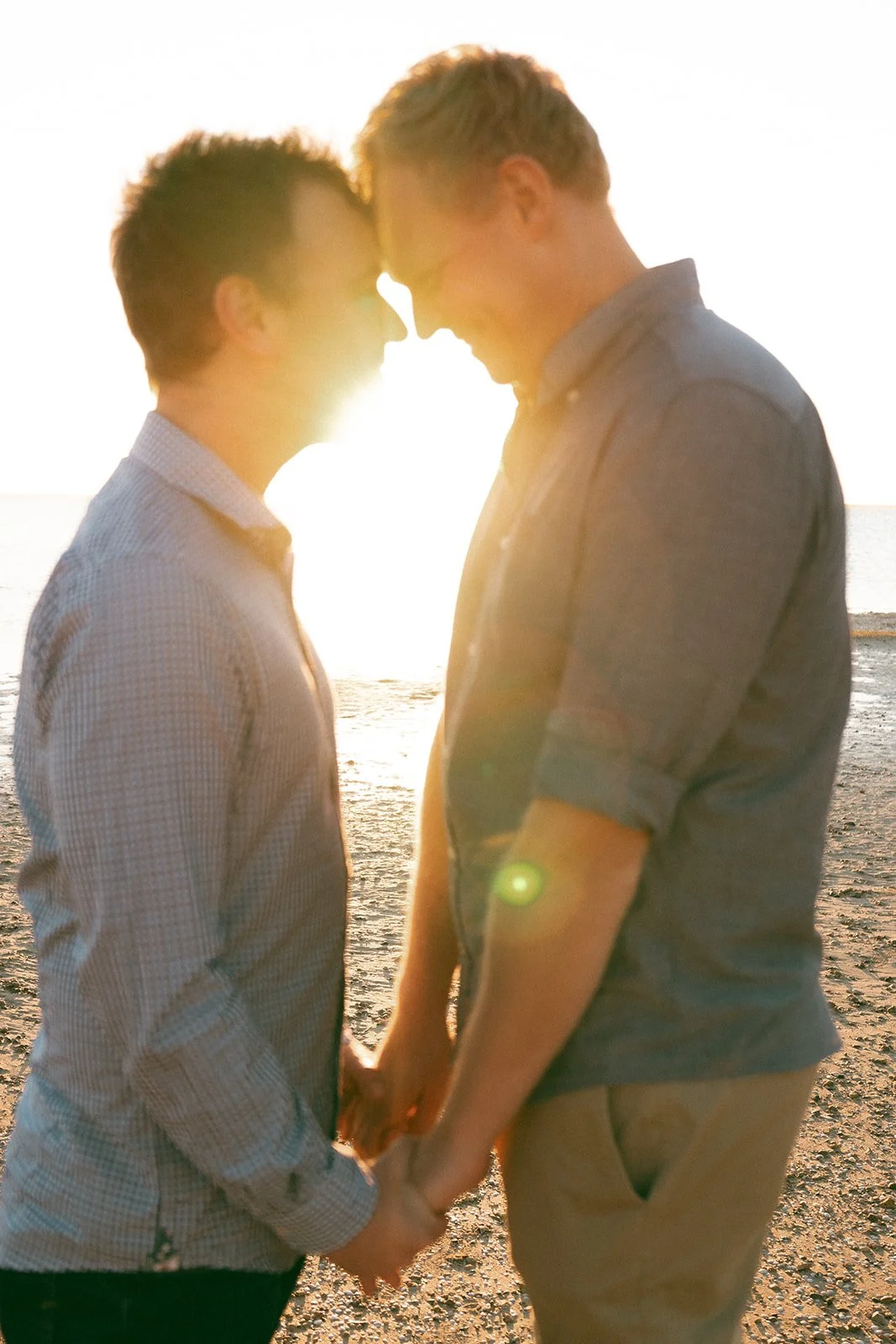 two gay men holding hands at sunset during their engagement session in ceduna eyre peninsula