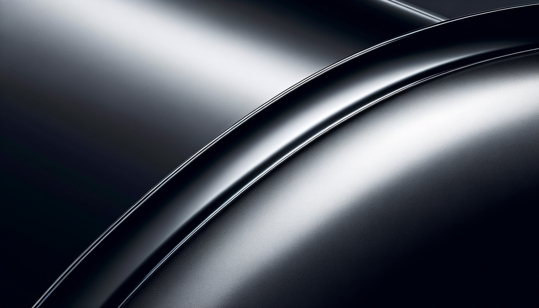 Close-up of a shiny, black metallic car surface with smooth curves.