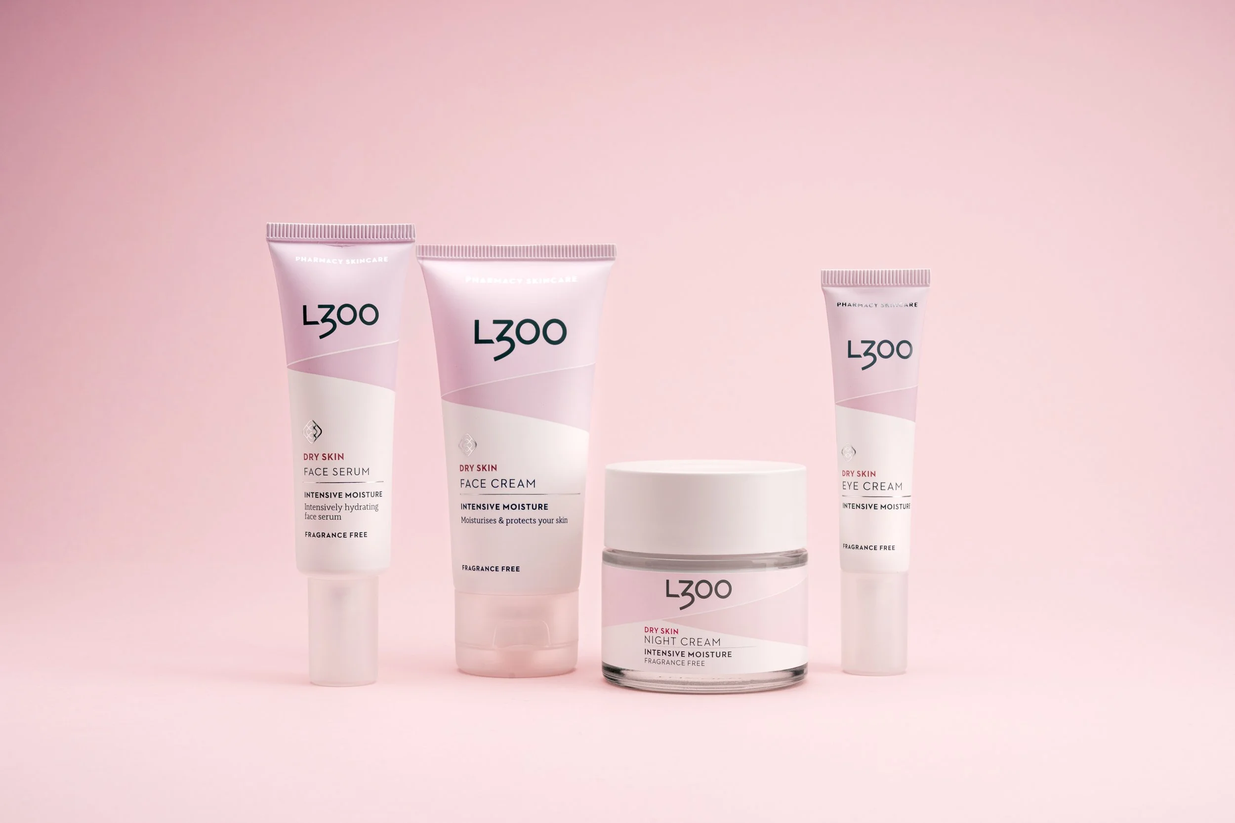 Array of pink skincare products labeled L300 on a pink background.