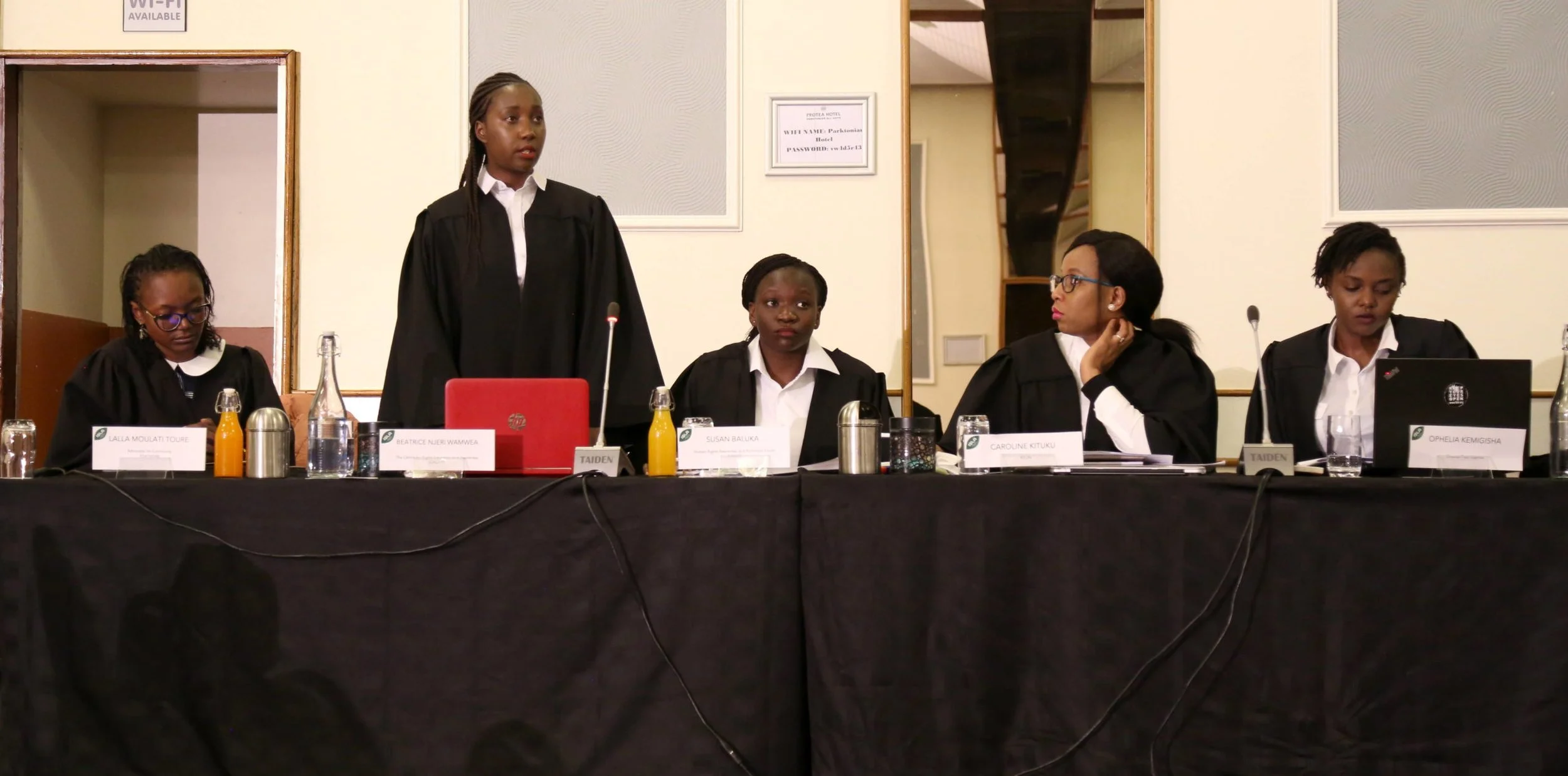 Three female lawyers sitting at a desk