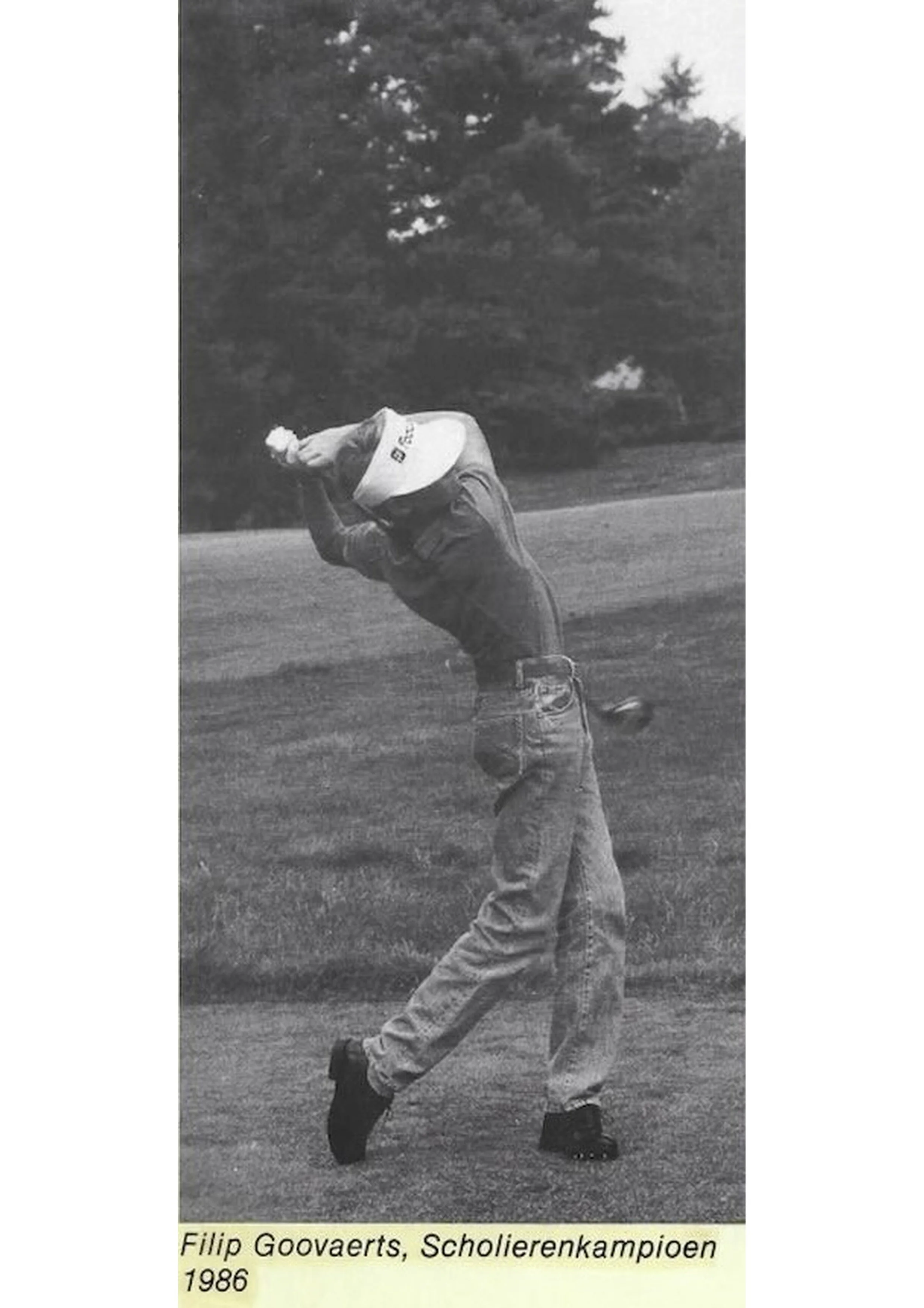 Zwart-wit foto van Filip Goovaerts, een scholierenkampioen uit 1986, die op het grasveld staat en zich voorbereidt op een worp.