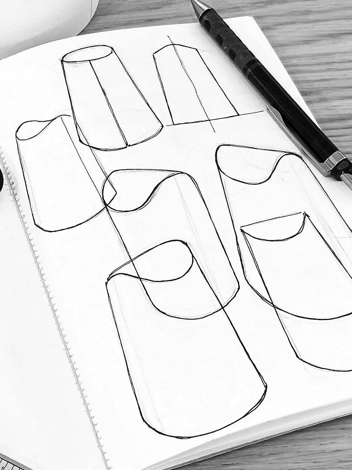 Flippy waste bin designed by Andrew Roberts, featuring a cone-shaped rolled steel body with fitted pivoting lid and minimal welded construction for modern interior use.