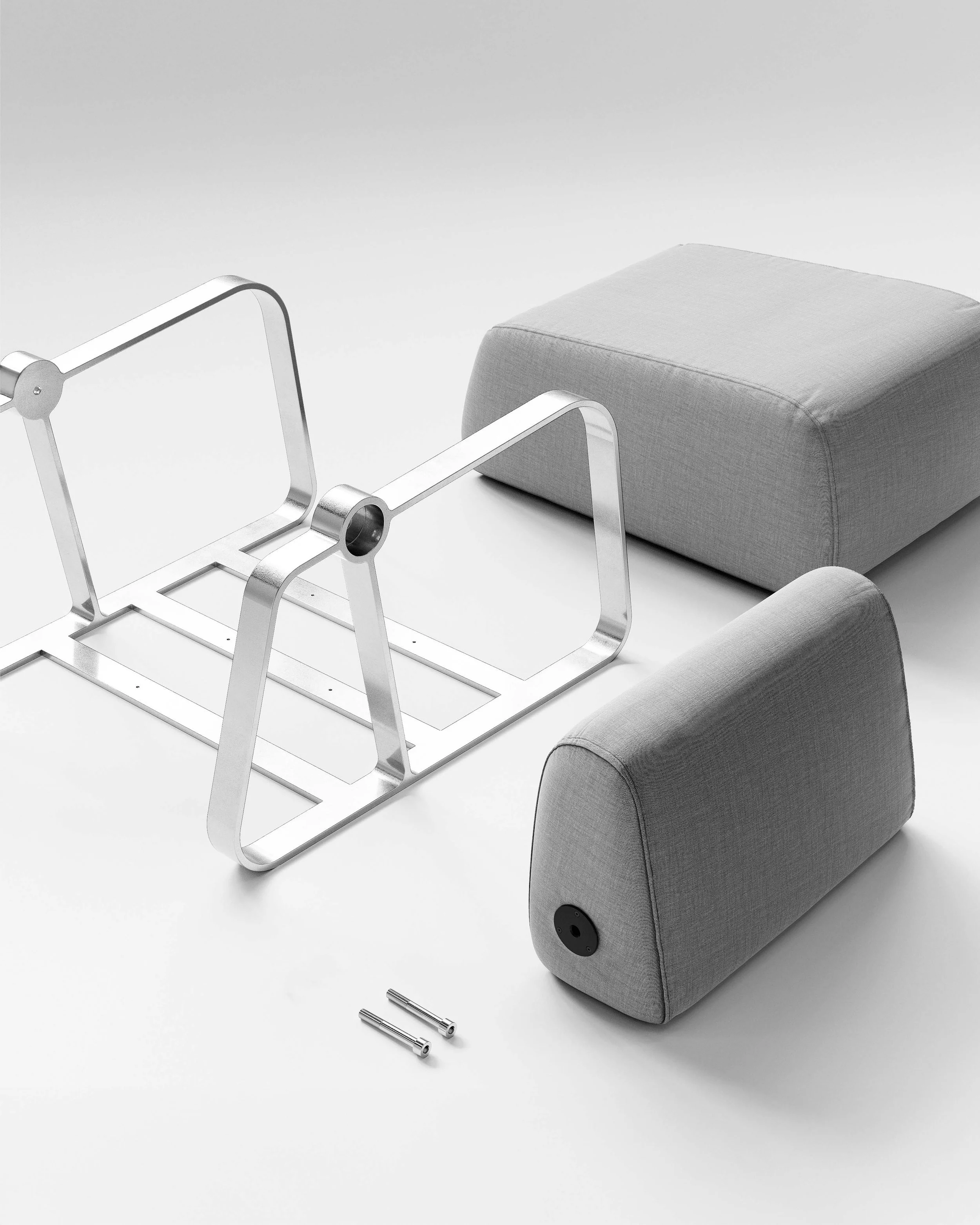 Putney Chair by New Zealand designer Andrew Roberts — a contemporary lounge chair combining soft moulded foam upholstery with a cast aluminium frame and armrests, designed for comfort, durability, and modern interior spaces.