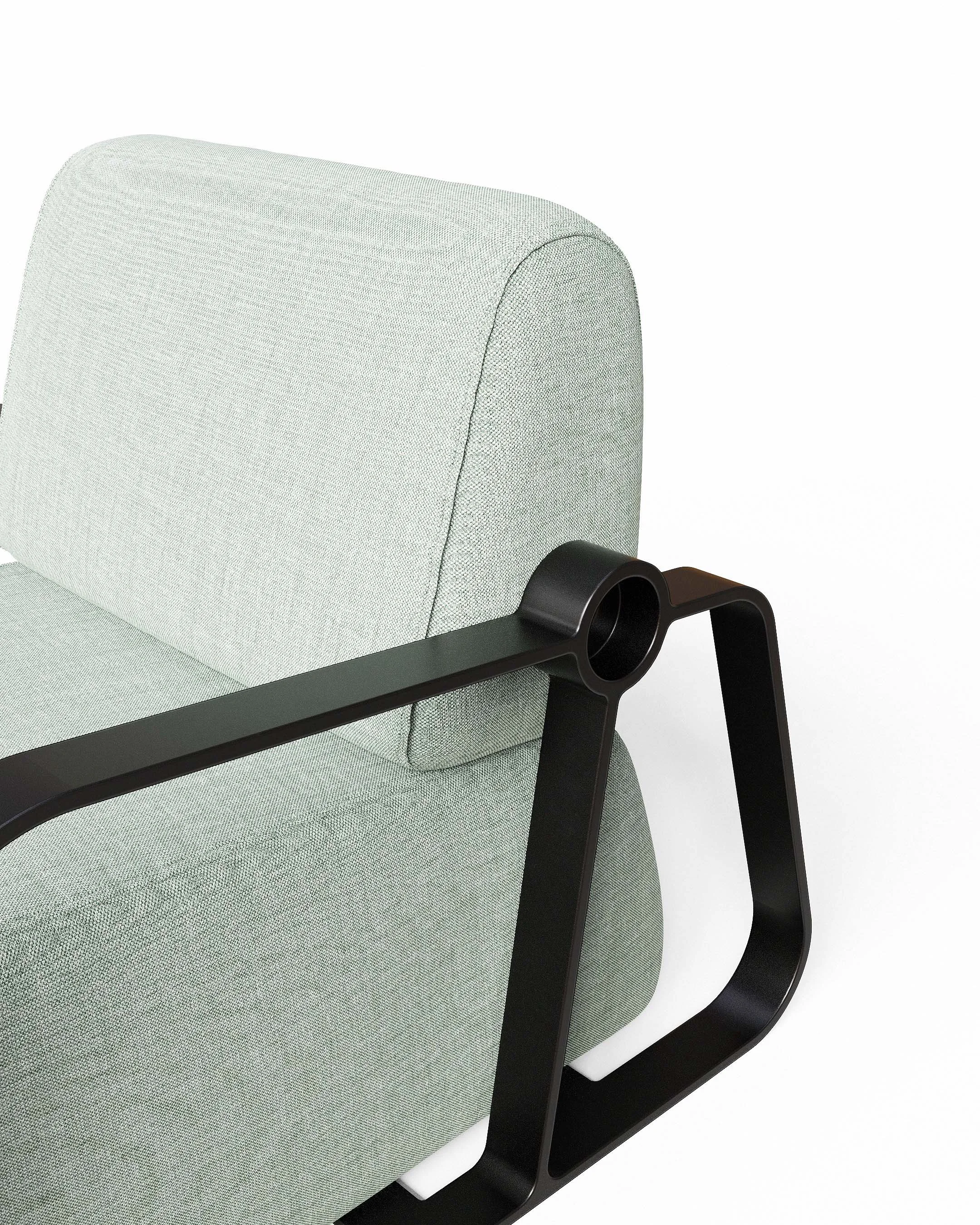Putney Chair by New Zealand designer Andrew Roberts — a contemporary lounge chair combining soft moulded foam upholstery with a cast aluminium frame and armrests, designed for comfort, durability, and modern interior spaces.