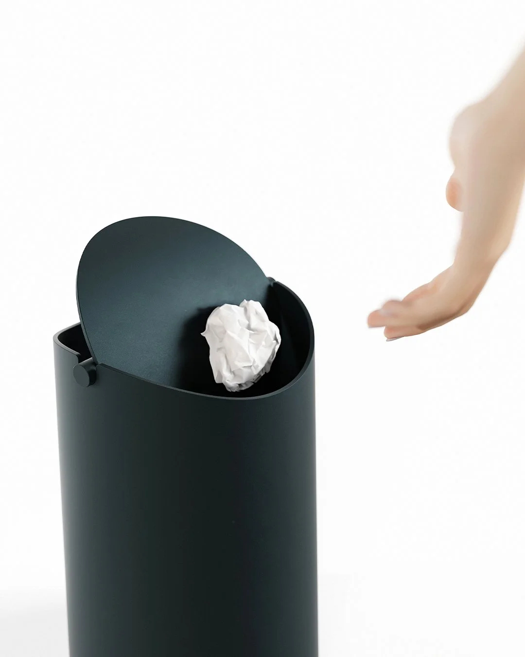 Flippy waste bin designed by Andrew Roberts, featuring a cone-shaped rolled steel body with fitted pivoting lid and minimal welded construction for modern interior use.