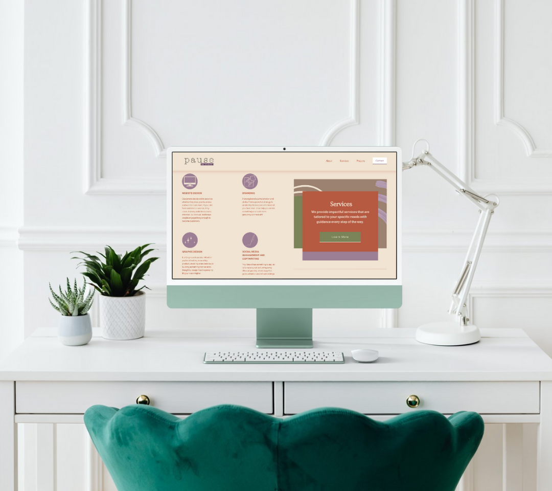 Digital workspace with a desktop computer on a white desk, flanked by potted plants, a white desk lamp, a keyboard, and a mouse, set against a white paneled wall.