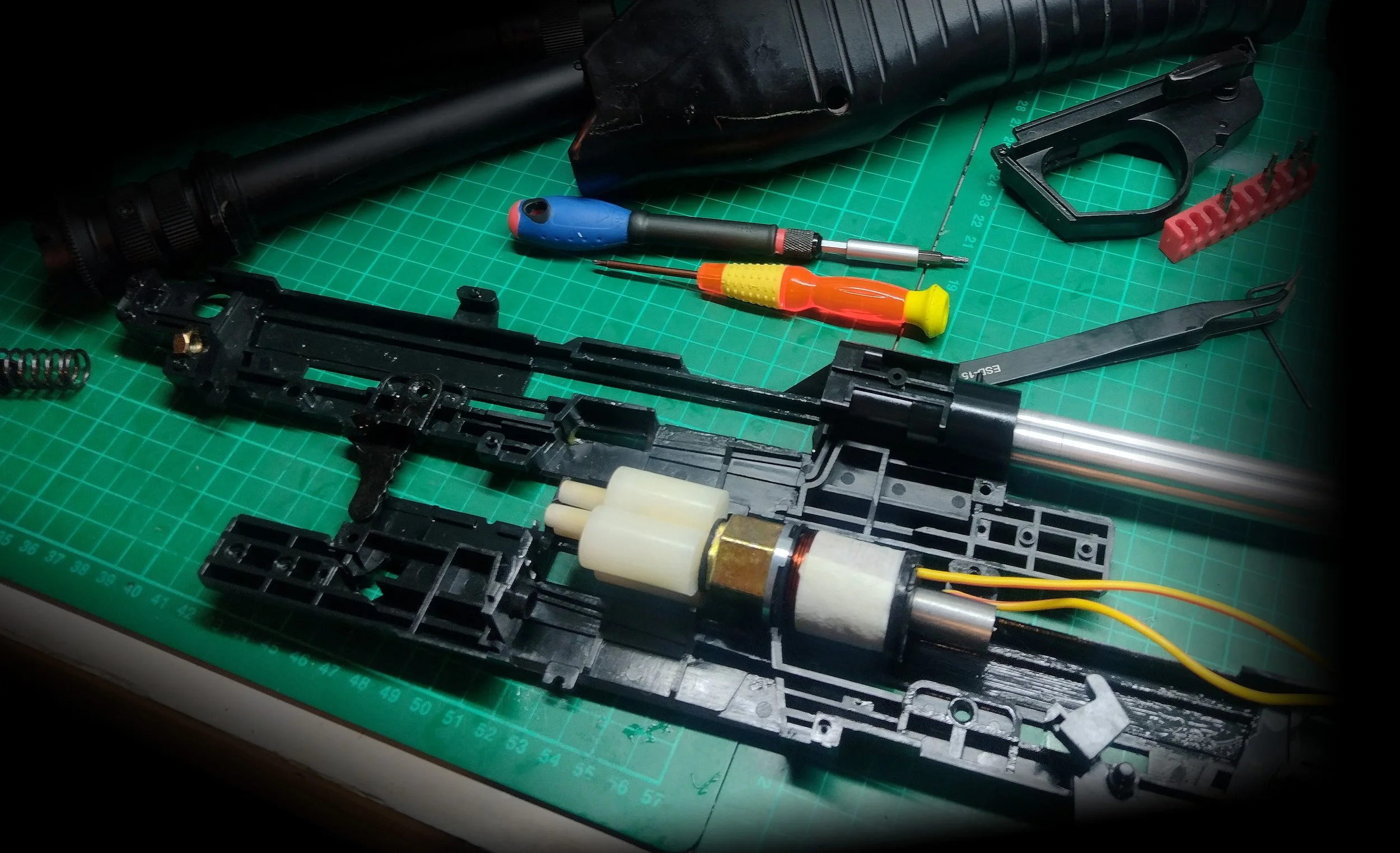 Spas-12 HPA airsoft shotgun internal work with parts laid and and screwdrivers 