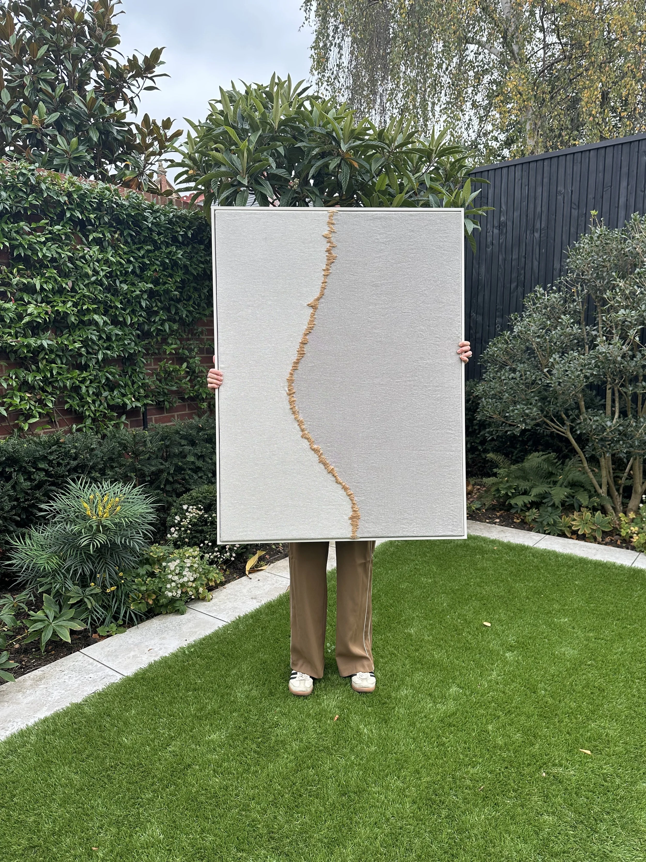 An extra large contemporary handcrafted original textile artwork using luxury fabric remnants and featuring a handspun hand dyed wool.