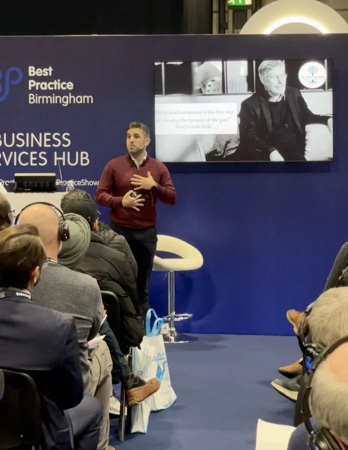 Dr Matt Slavin, Clinical Psychologist speaking in front of an audience at the Business Services Hub in Birmingham, during a presentation or talk.