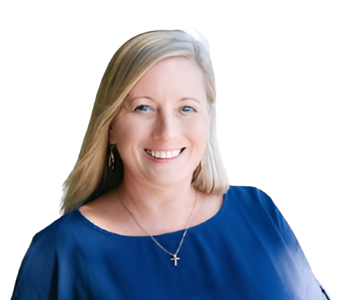 A smiling woman with blonde hair wearing a blue blouse and a cross necklace