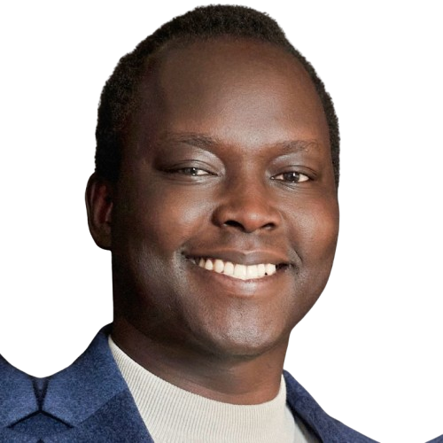 Portrait of a smiling man with short hair, wearing a blue jacket and a light-colored shirt, against a plain white background.