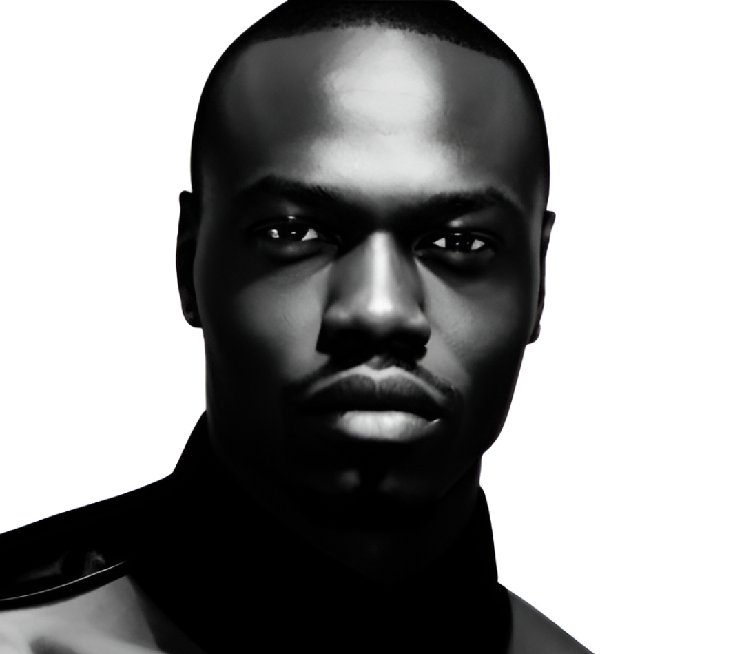 Black man with short hair in black clothing against a white background.
