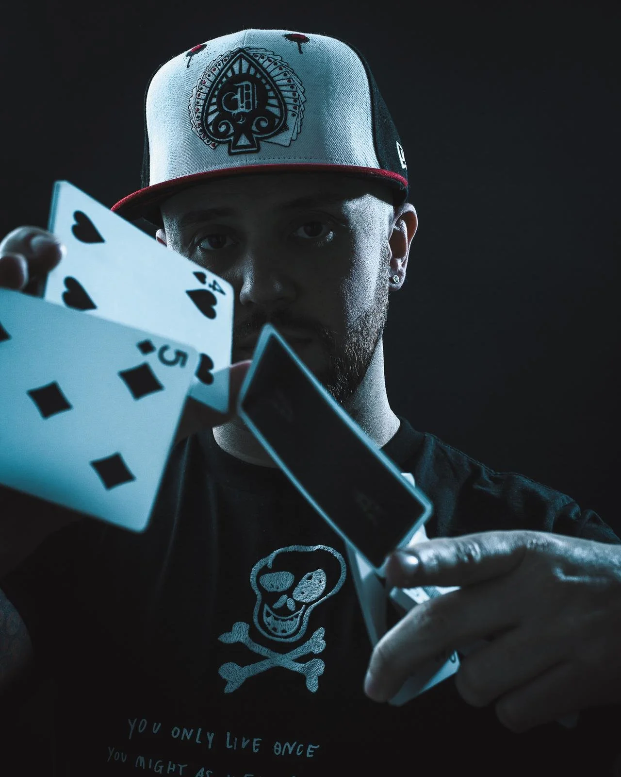 Damien O'Brien, magician and mind reader, holding a King of Spades playing card