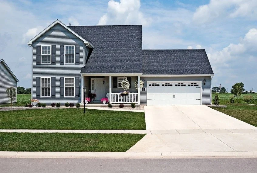 White Stamped Carriage House Garage Door on Two Story House
