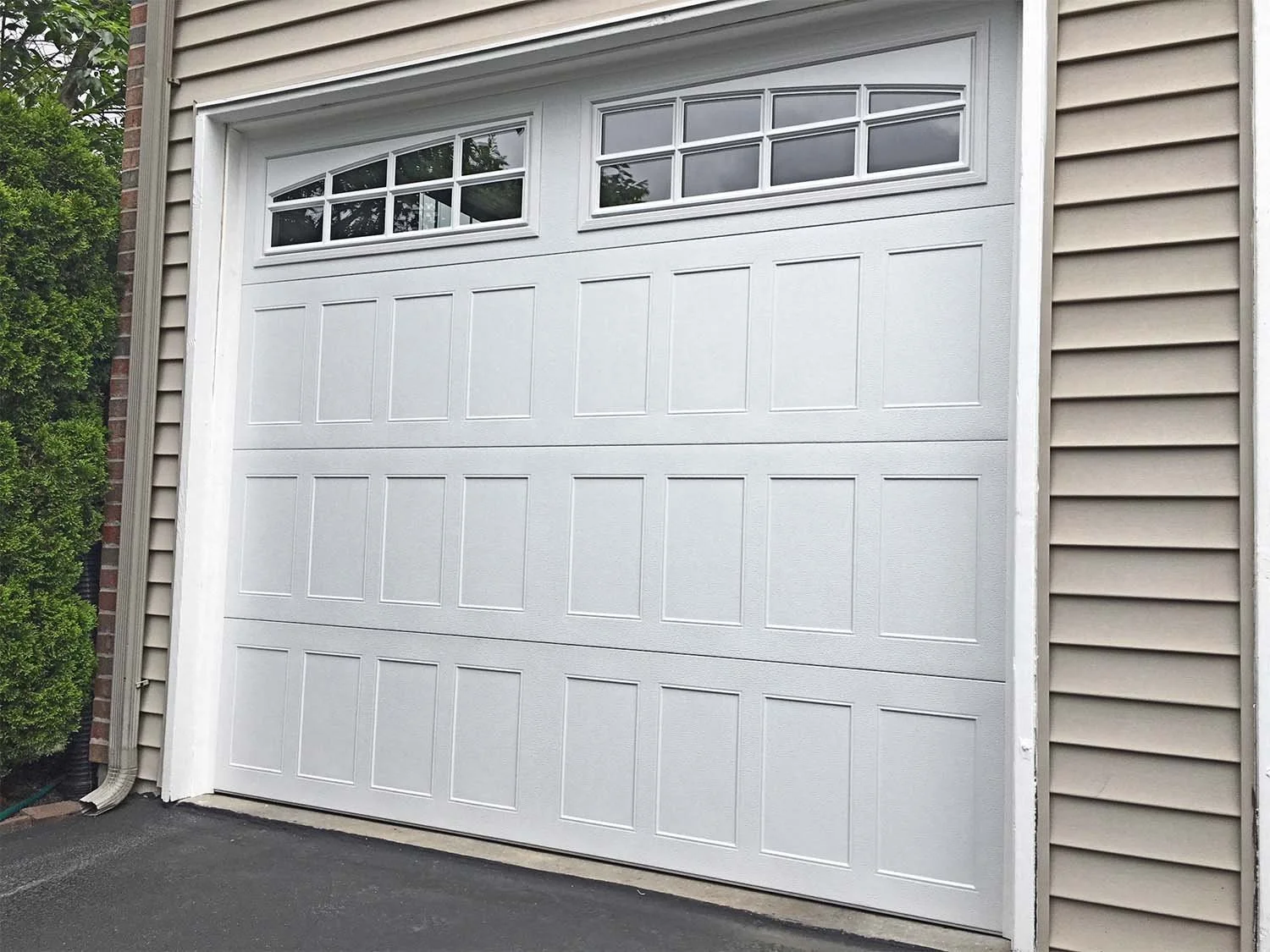 One White Stamped Shaker Garage Door on Paneled House