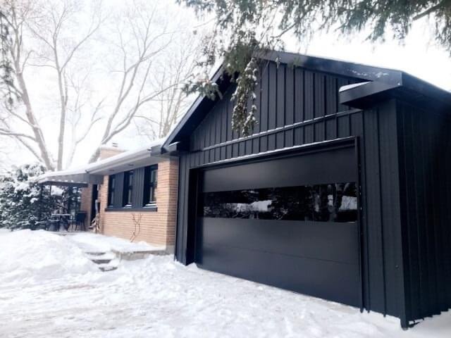 Black Sterling Garage Door on Black Paneled House