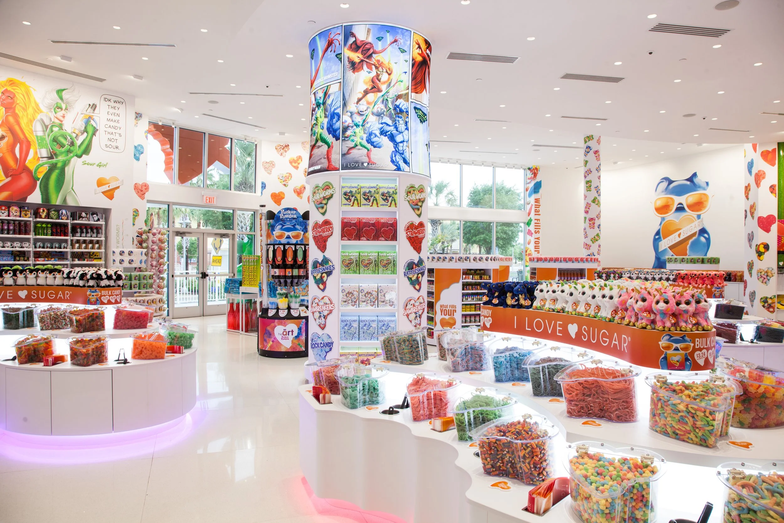 This is an interior of our I LOVE SUGAR Panama City Beach location.  You can see our heart-shaped candy bins with various sweets and vibrant wall art.